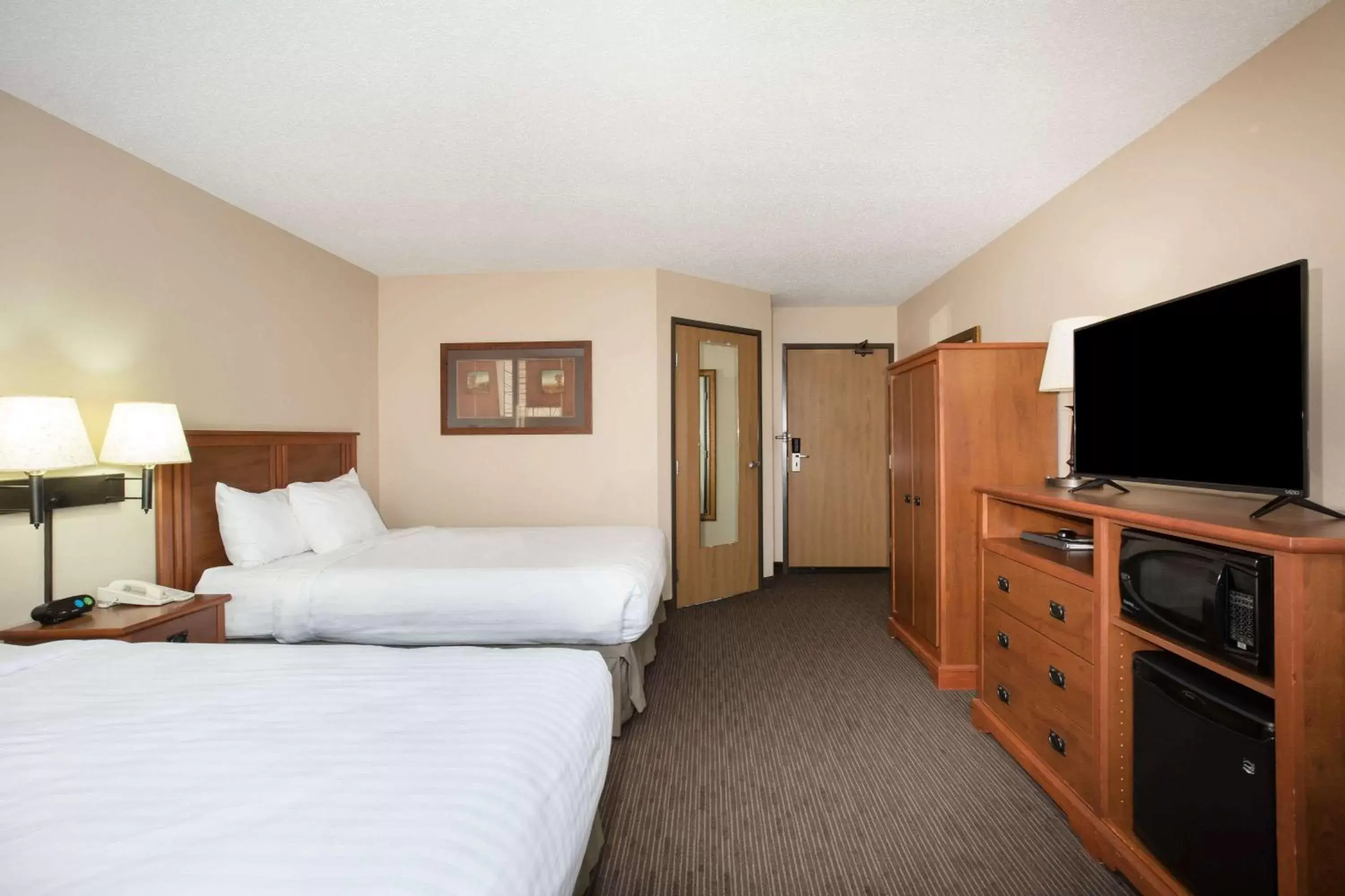 Photo of the whole room, TV/Entertainment Center in AmericInn by Wyndham Sioux City