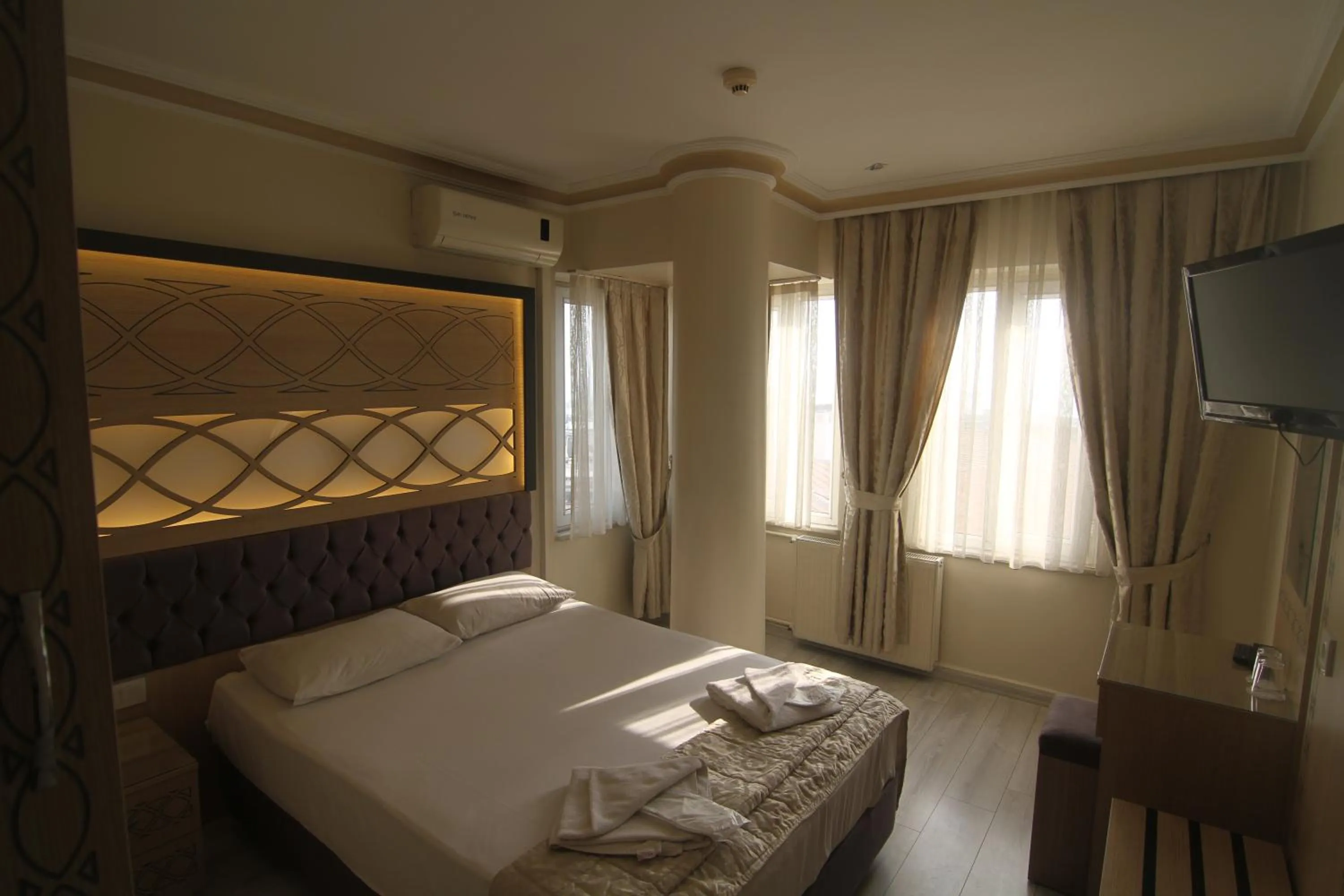 Bed in Grand Liza Hotel