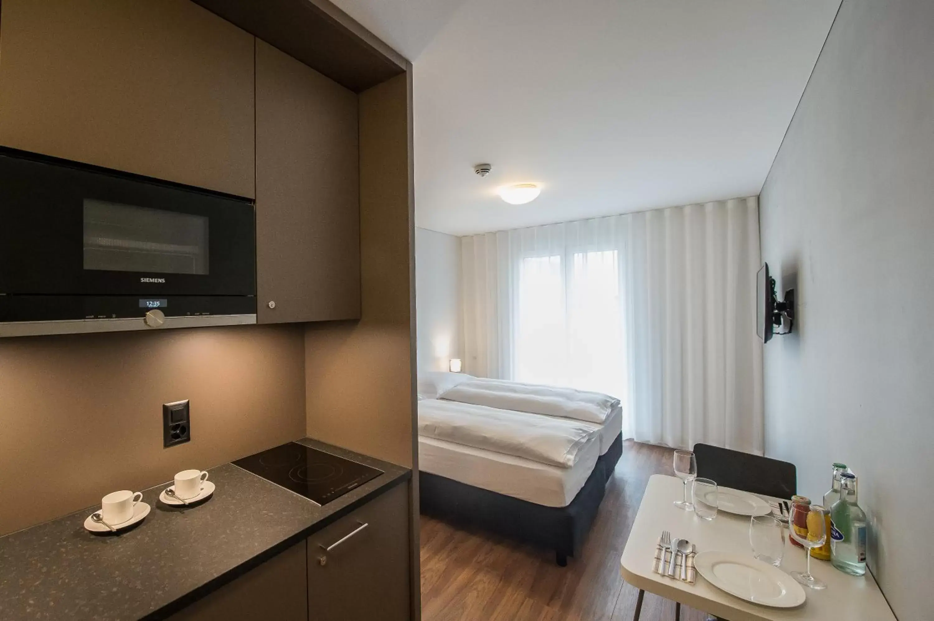 Kitchen or kitchenette, Bed in Aparthotel Baden