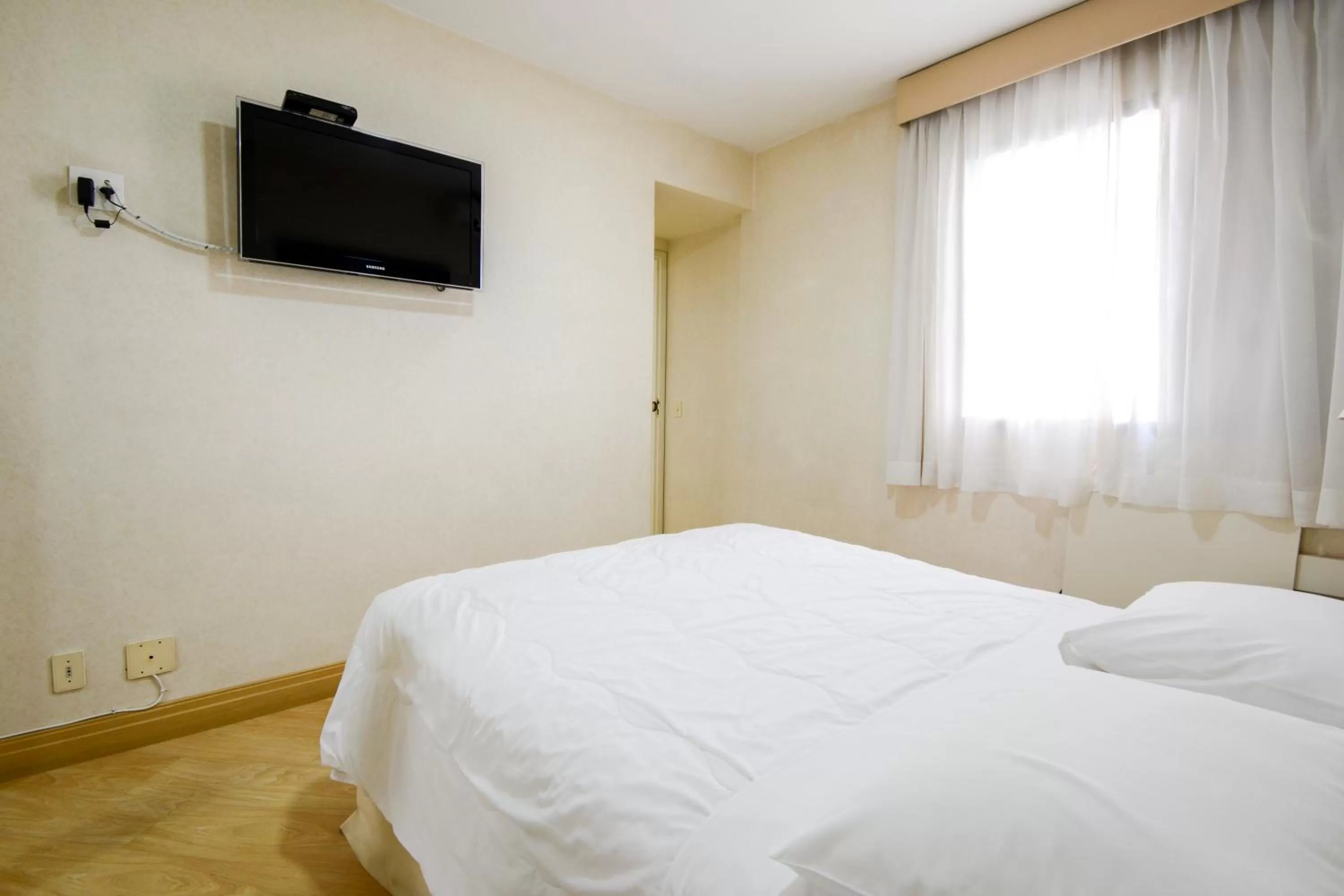 Bed in Wall Street Apartments by BnbHost