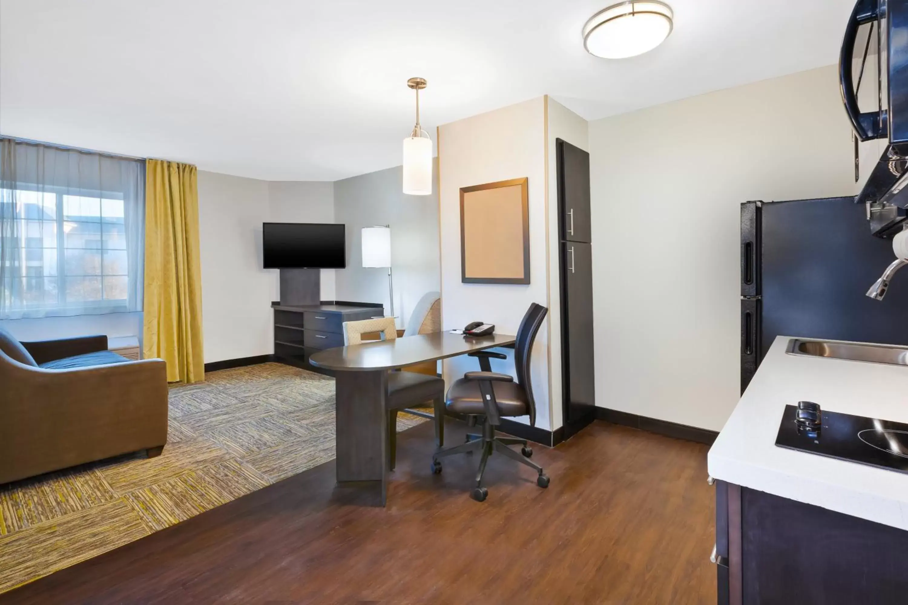 Photo of the whole room, TV/Entertainment Center in Candlewood Suites Huntersville-Lake Norman Area, an IHG Hotel