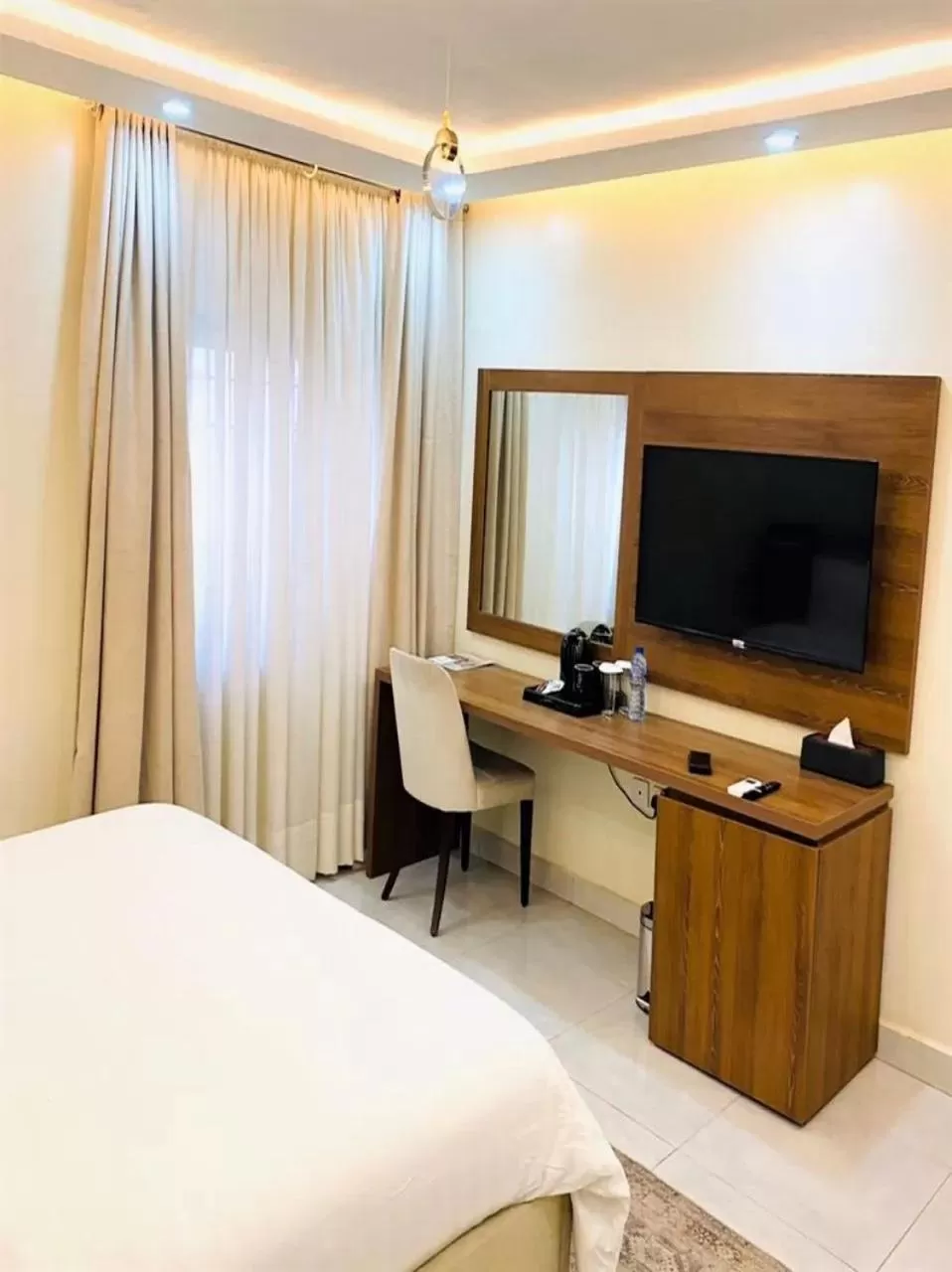 Bed, TV/Entertainment Center in Plush Hotel,Abuja