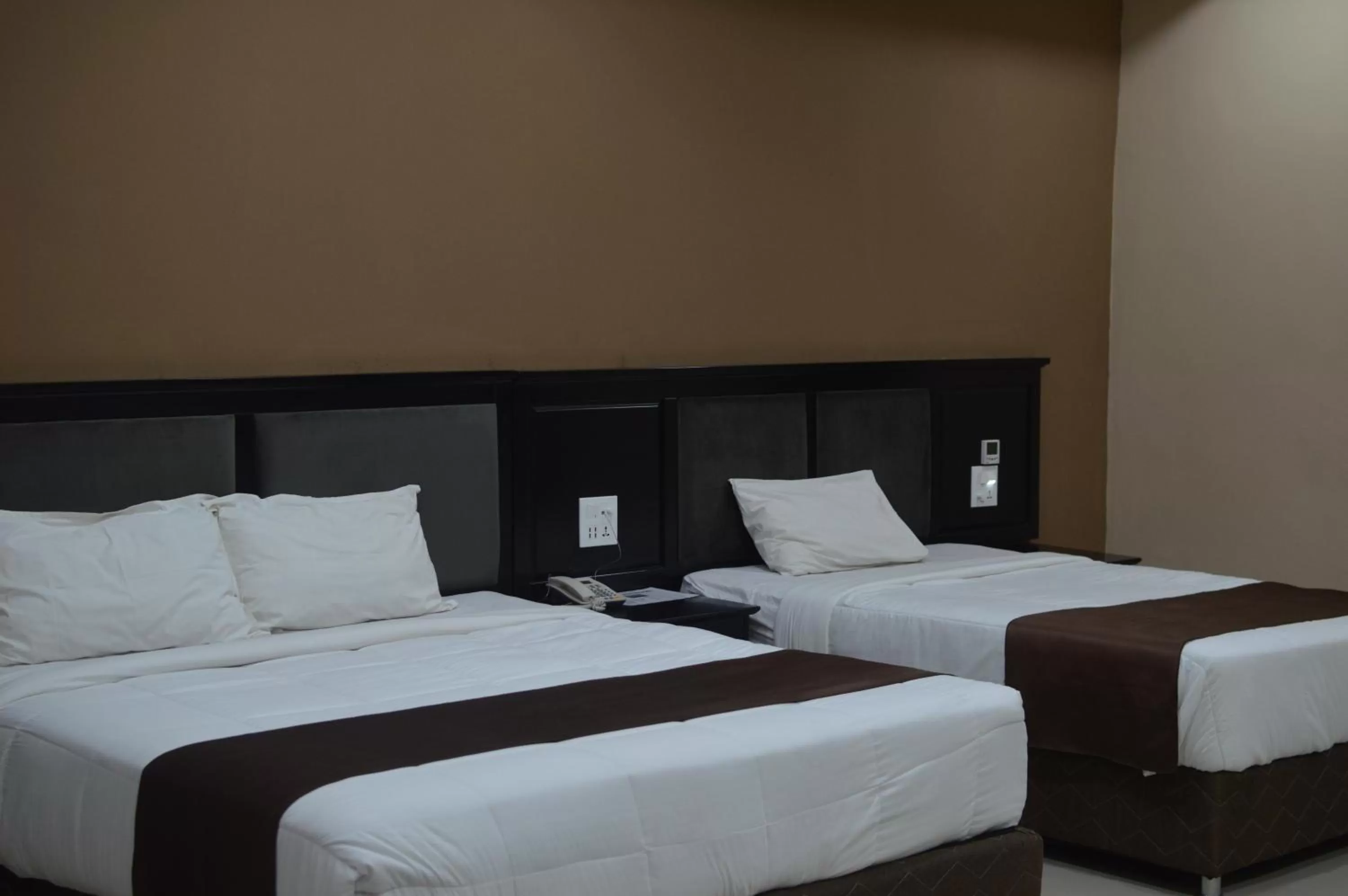 Bed in Palm Kalash Hotel