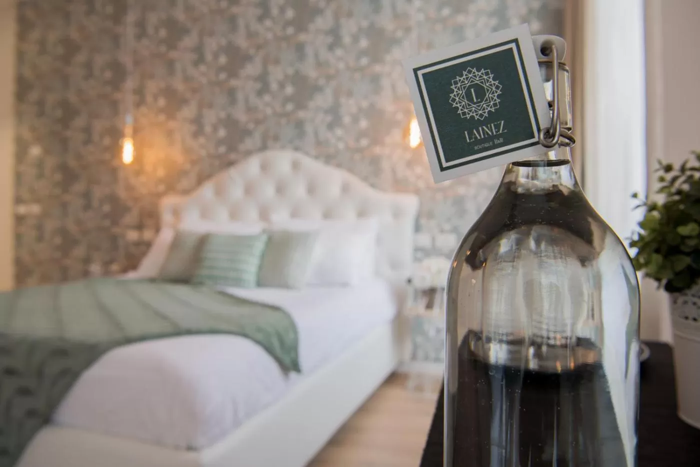 Property logo or sign, Bed in Lainez Rooms & Suites