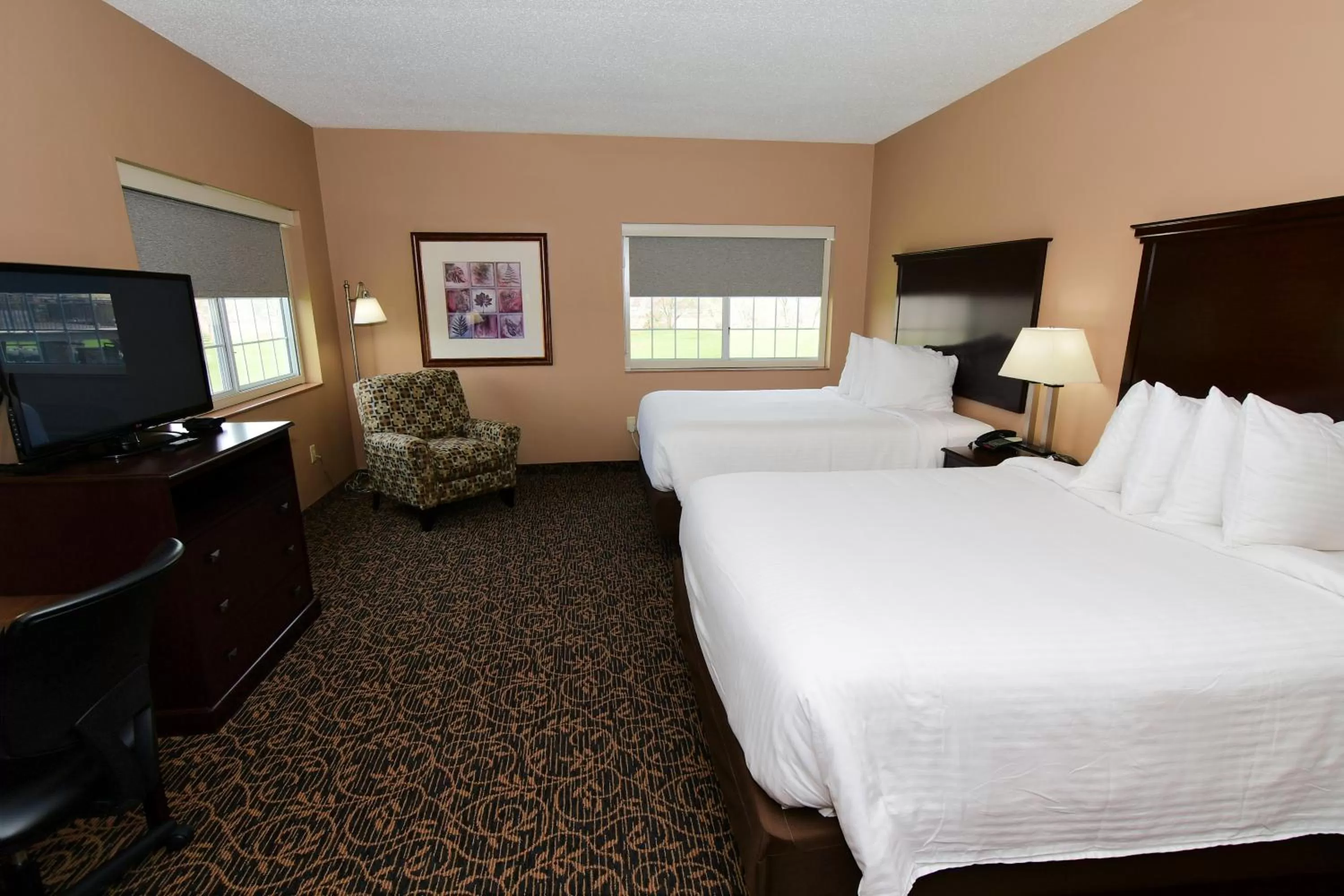 Bed in Cobblestone Inn & Suites - Denison | Majestic Hills