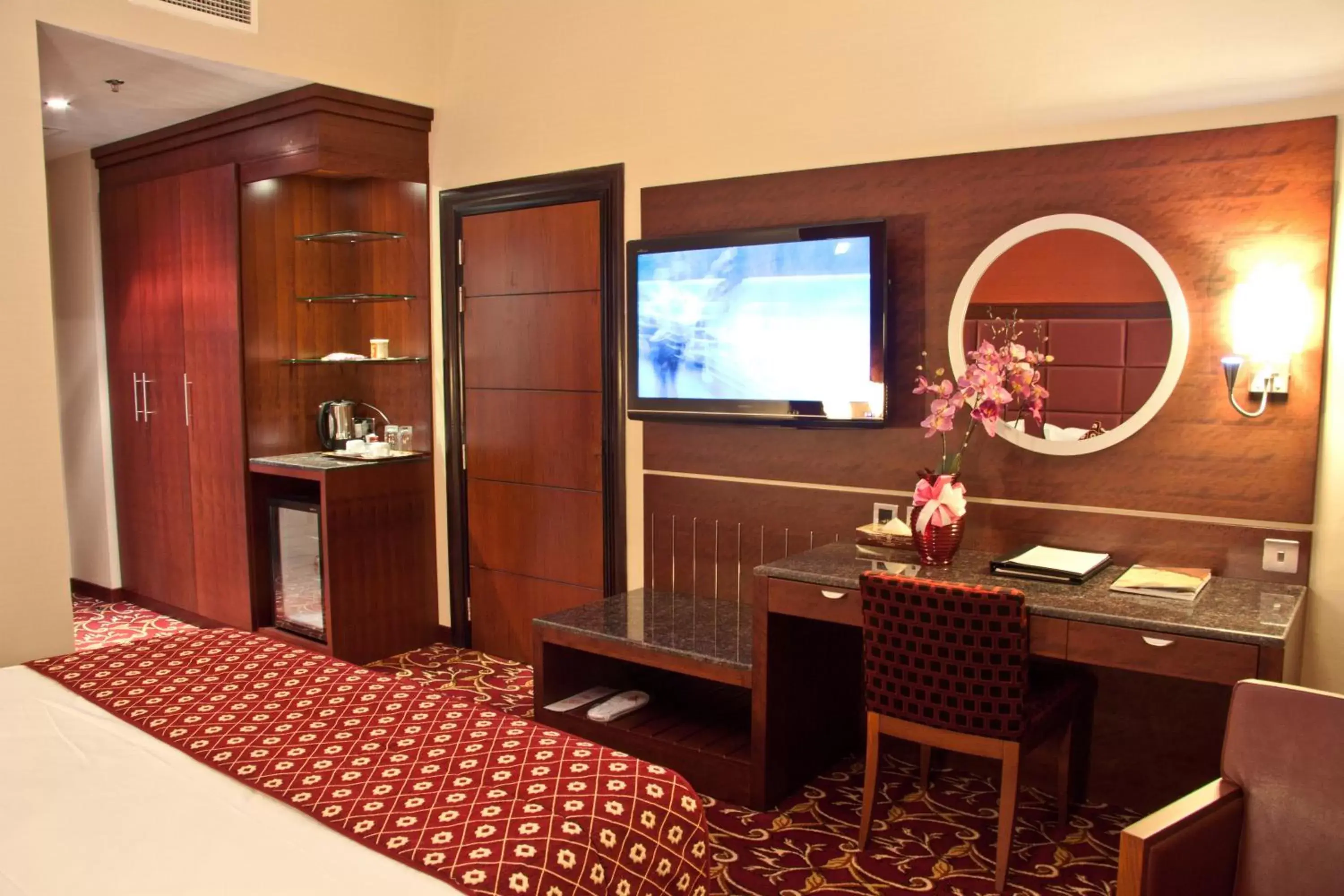 Bed, TV/Entertainment Center in Ramee Rose Hotel