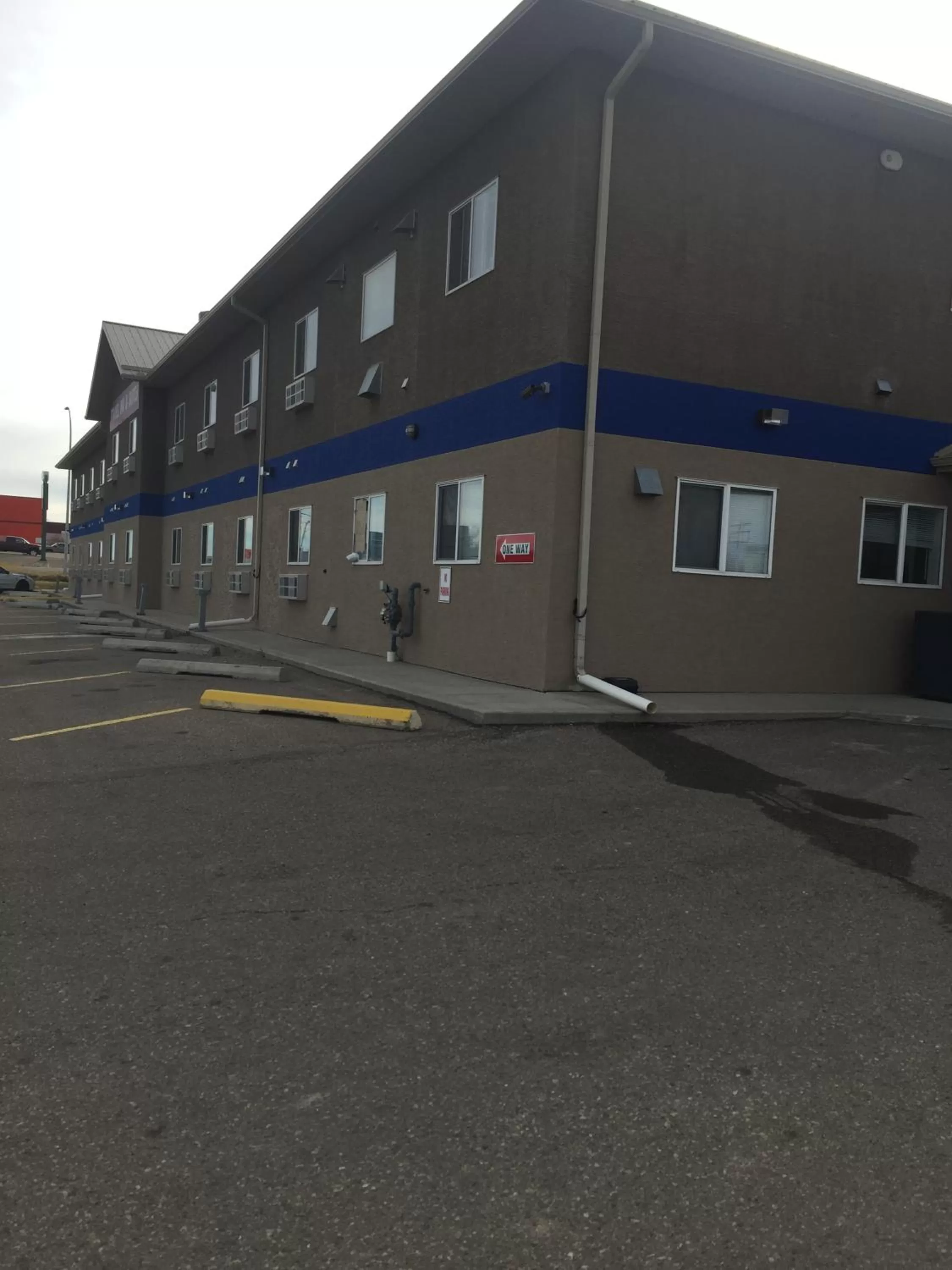 Parking, Property Building in Travel Inn & Suites