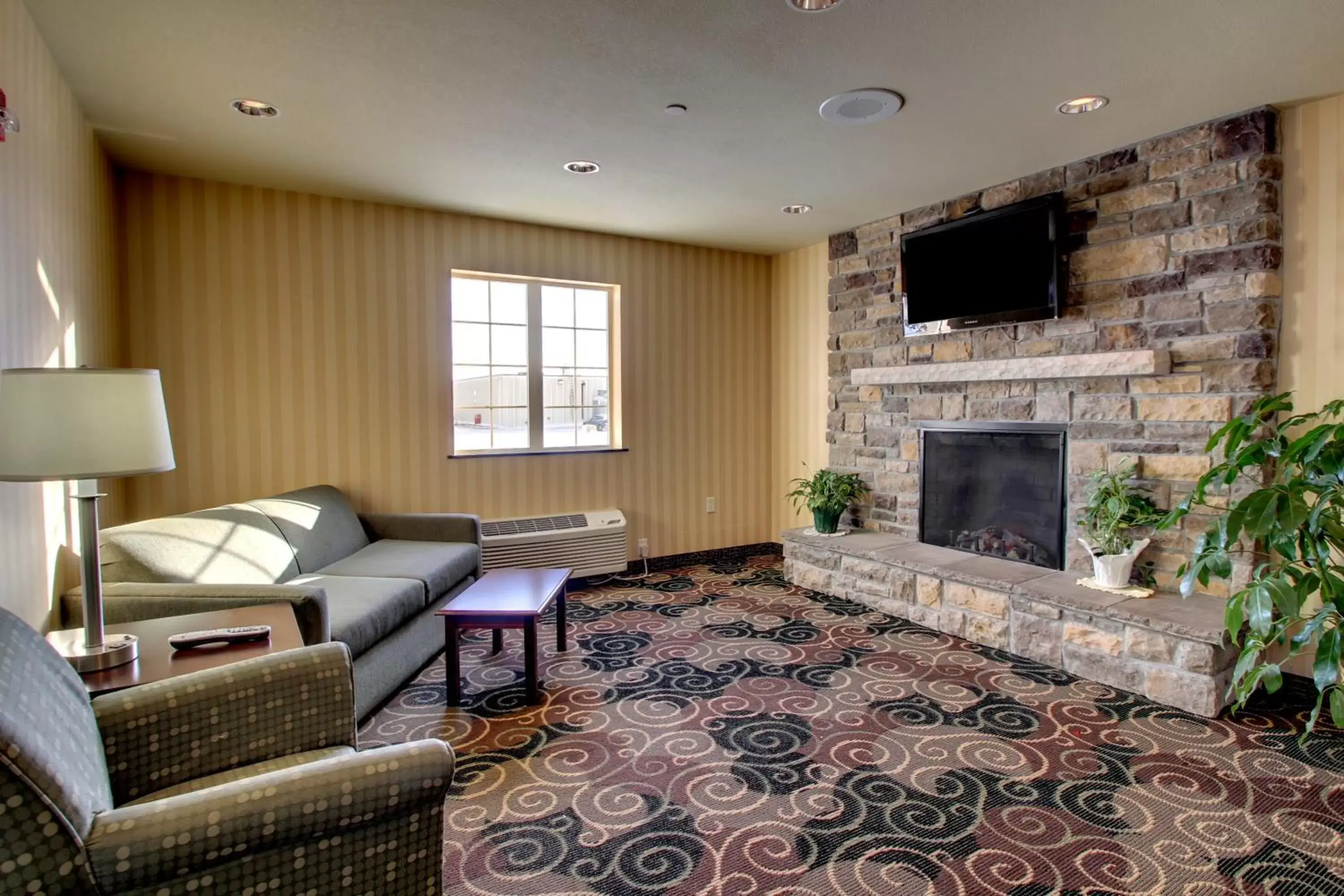 Communal lounge/ TV room, Seating Area in Cobblestone Inn & Suites - Carrington