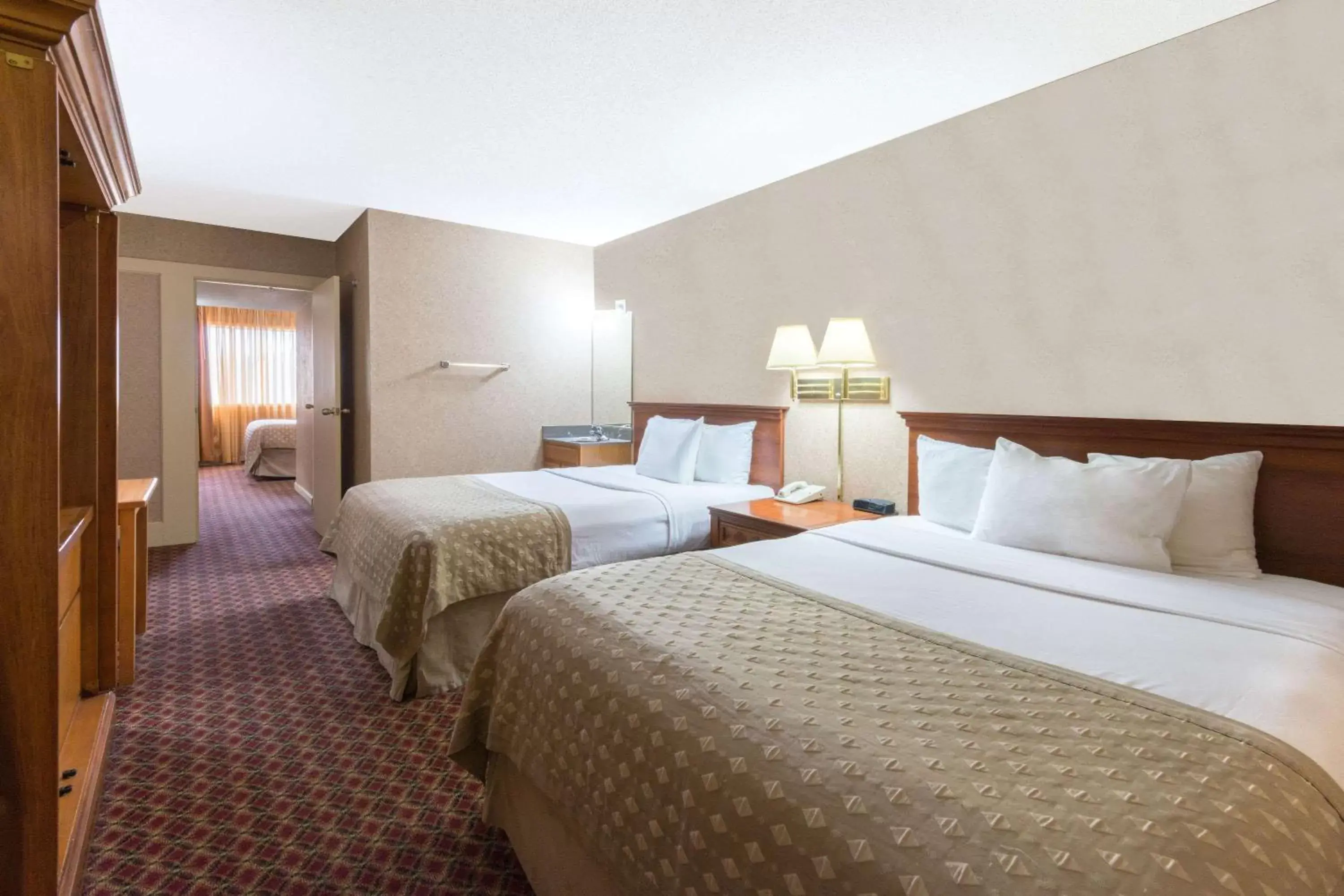 Photo of the whole room, Bed in Ramada by Wyndham Topeka Downtown Hotel & Convention Center