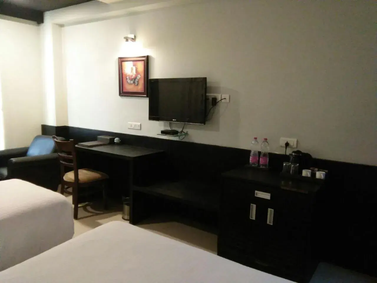 Bed, TV/Entertainment Center in Pride Ananya Resort Puri