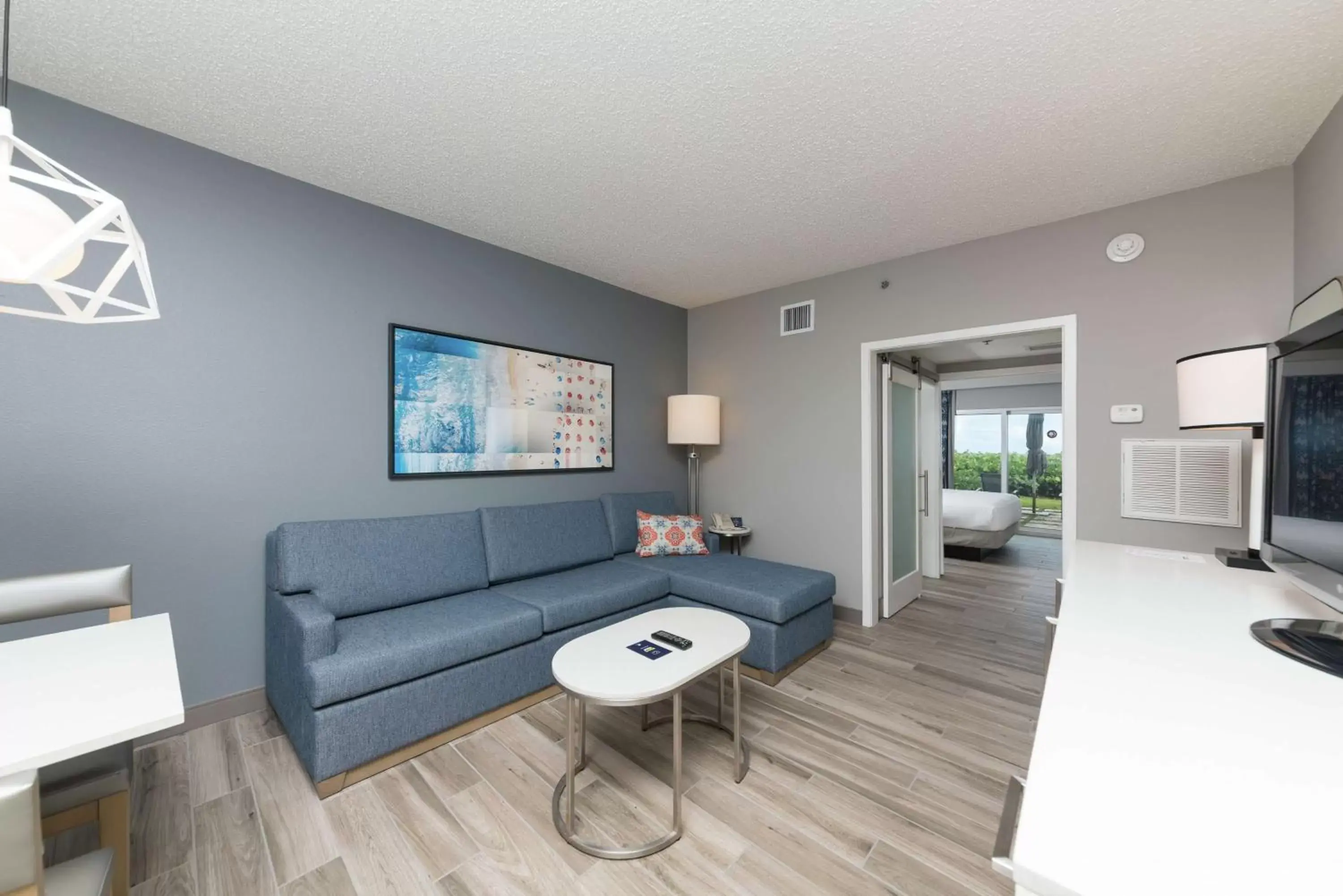 Bed, Seating Area in DoubleTree Suites by Hilton Melbourne Beach Oceanfront