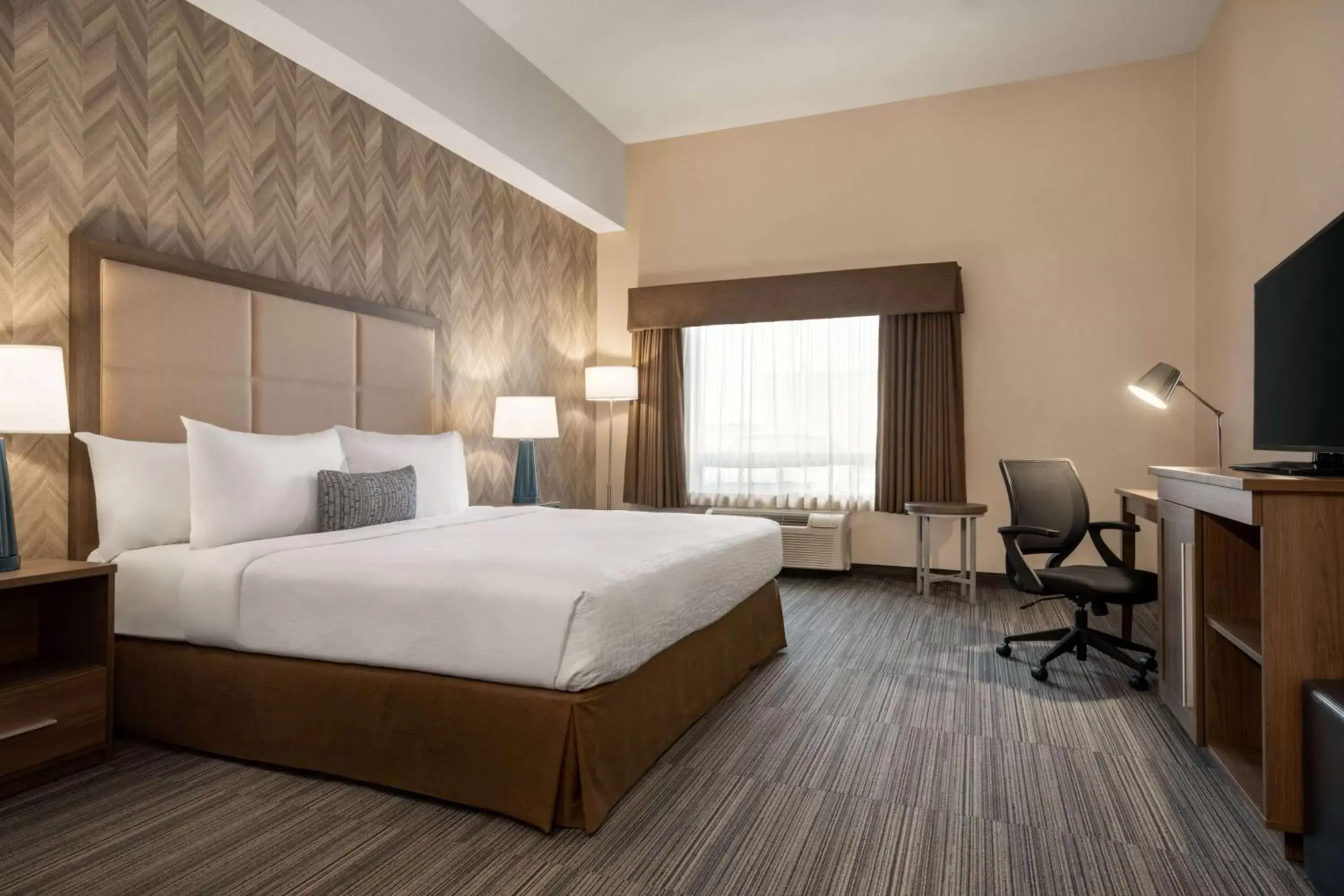 Photo of the whole room, Bed in Ramada by Wyndham Airdrie Hotel & Suites