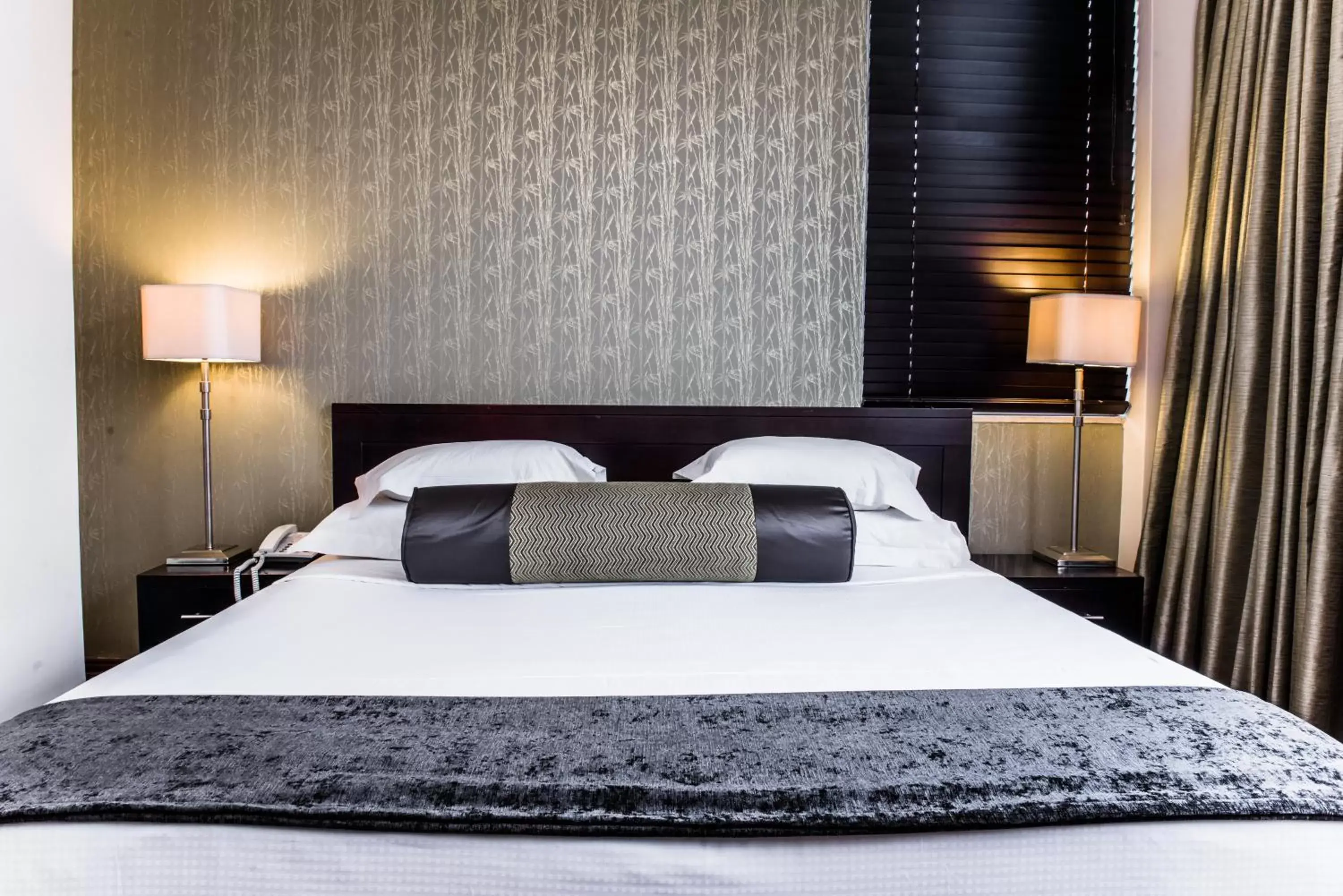 Bed in Belaire Suites Hotel