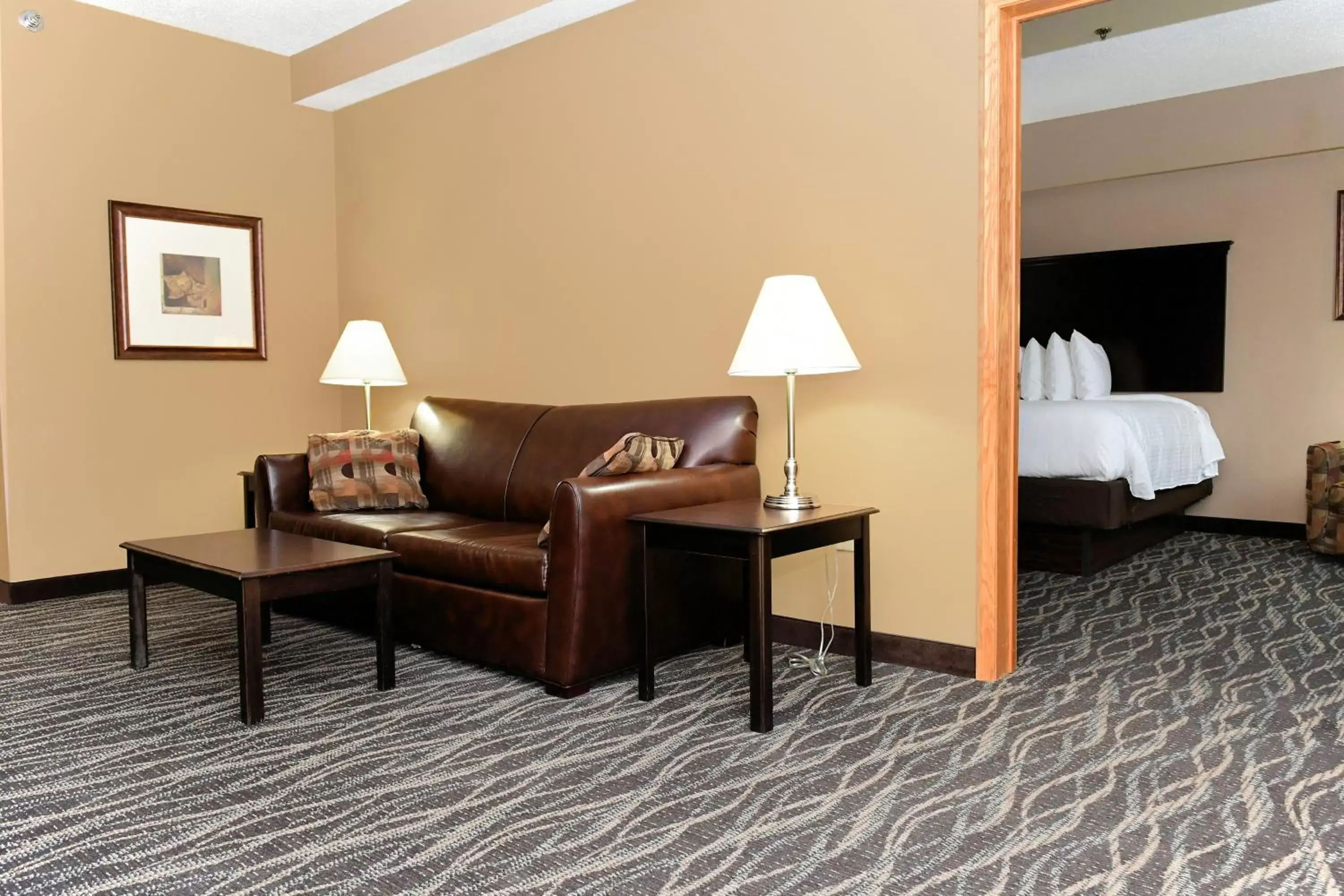 Bed, Seating Area in Cobblestone Inn & Suites - Denison | Majestic Hills