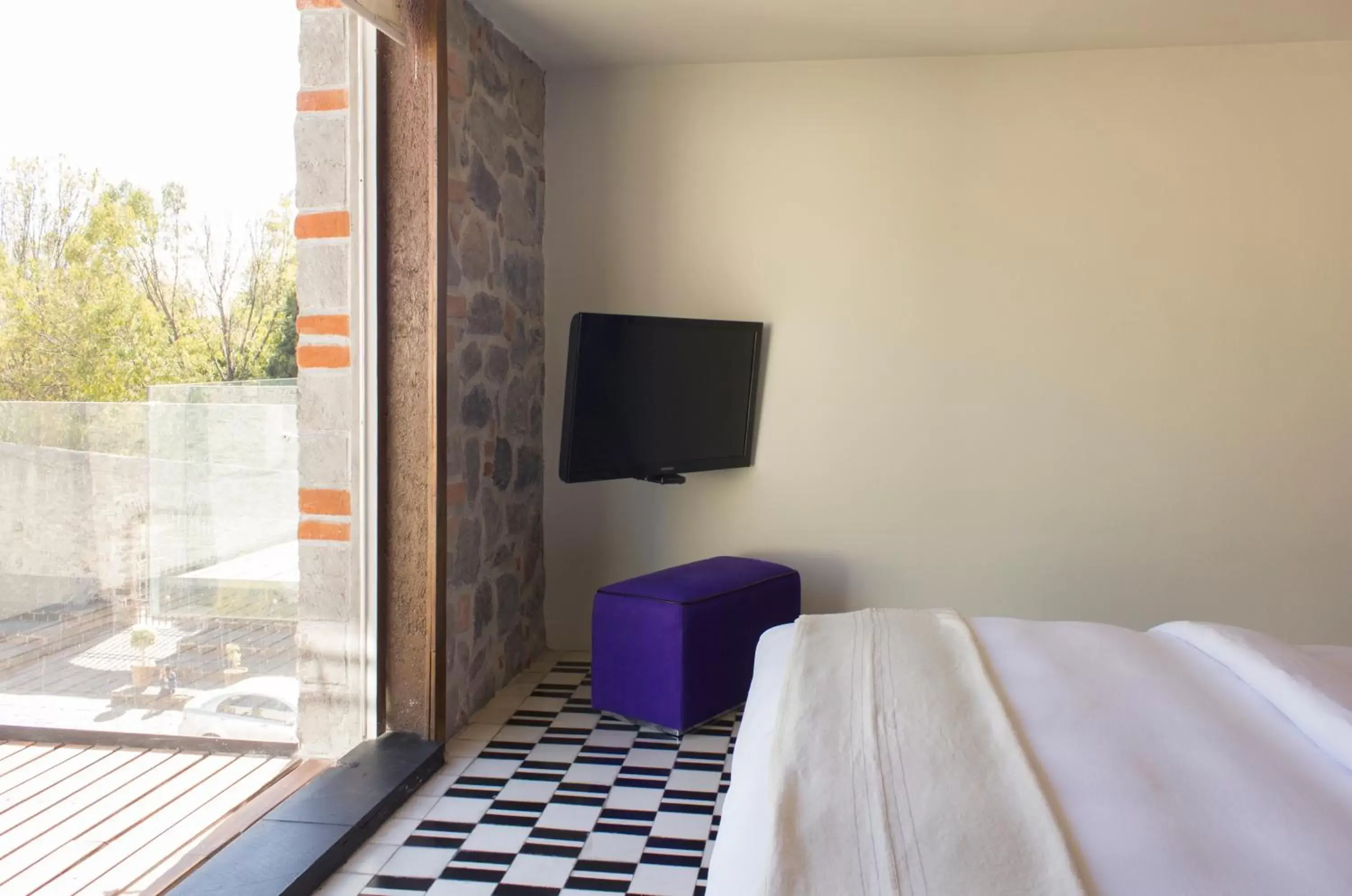 Bedroom, TV/Entertainment Center in La Purificadora, Puebla, a Member of Design Hotels