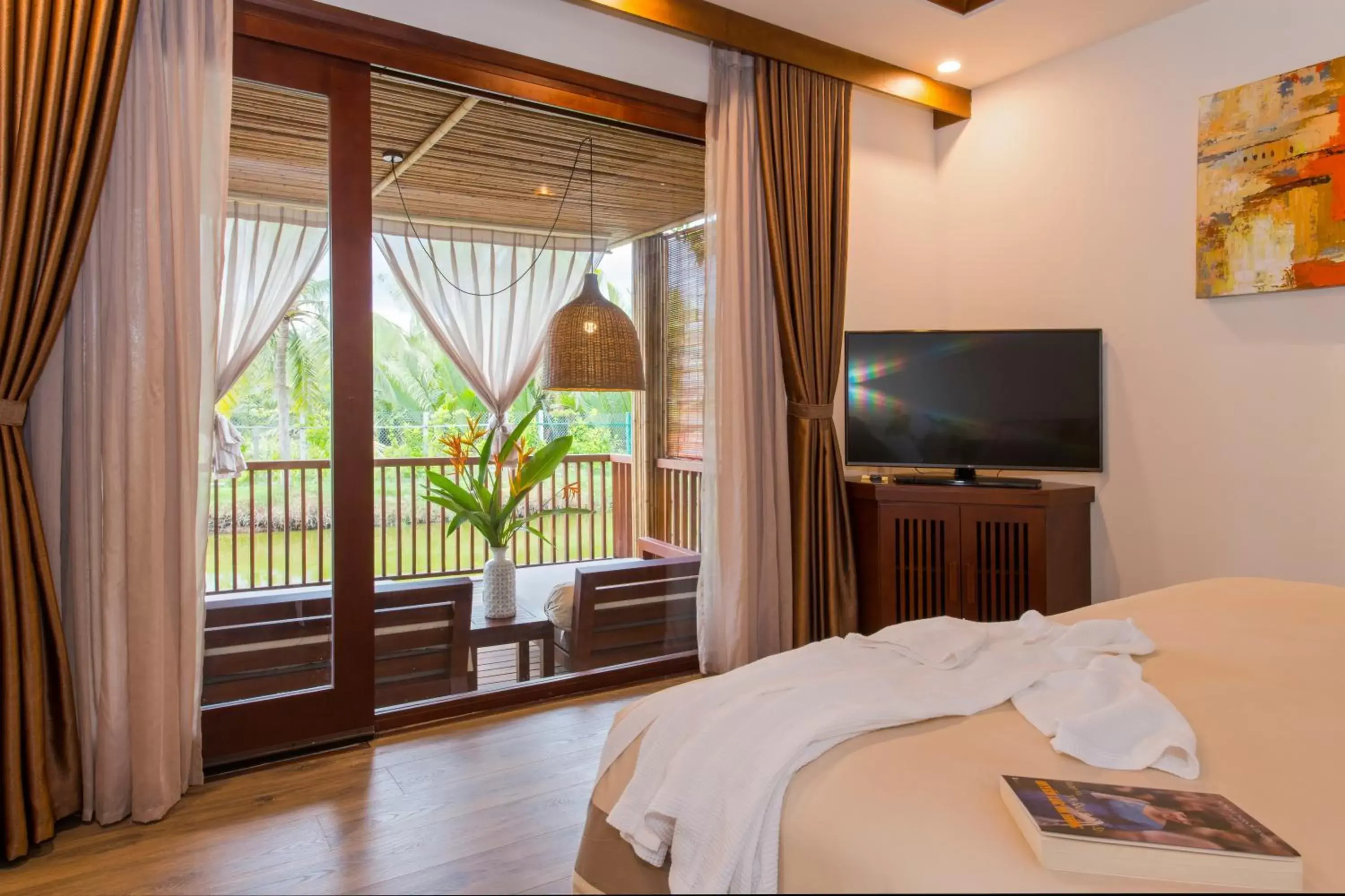 Bed, TV/Entertainment Center in Hoi An Eco Lodge & Spa