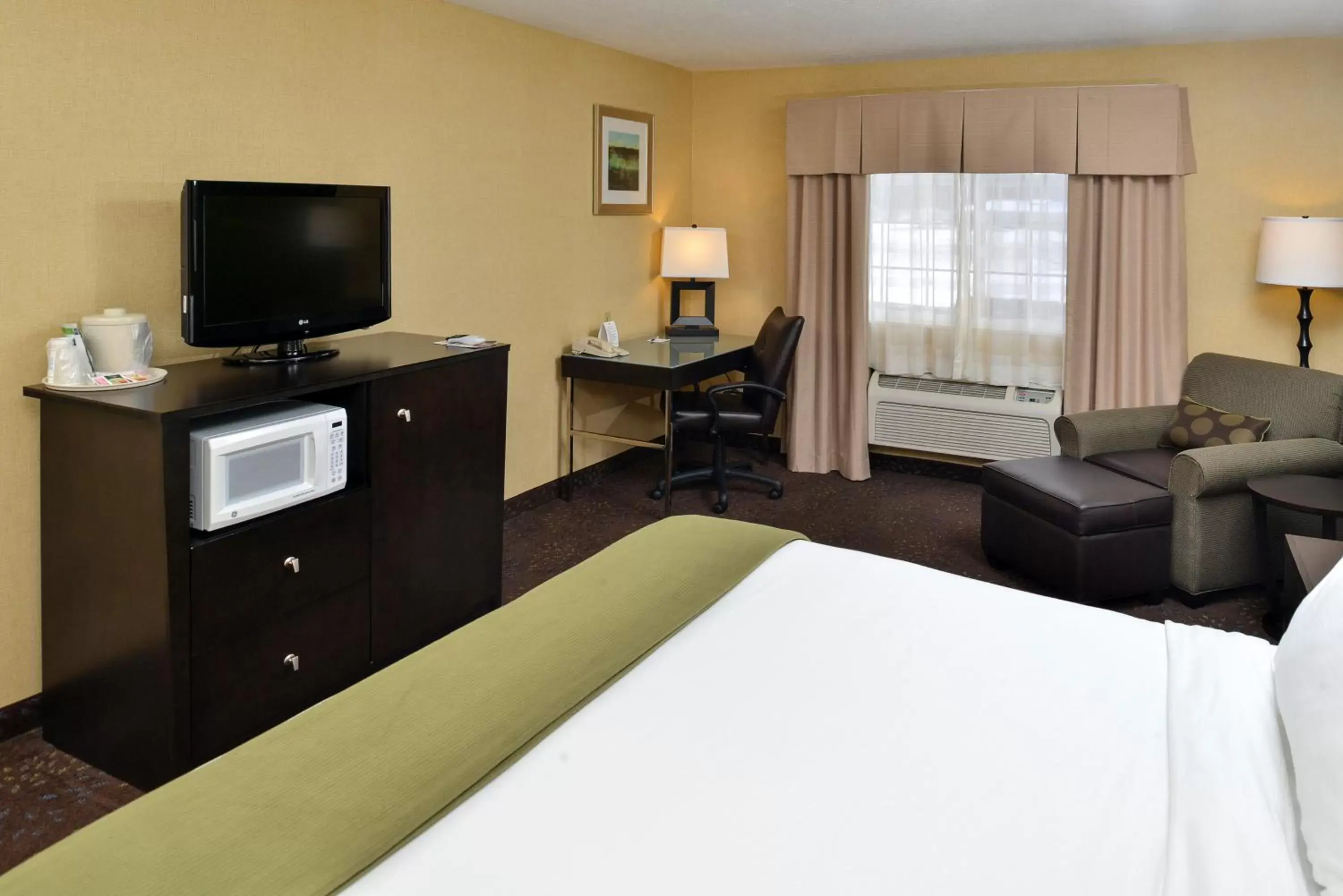 Photo of the whole room, TV/Entertainment Center in Holiday Inn Express Hotel & Suites Charlotte, an IHG Hotel