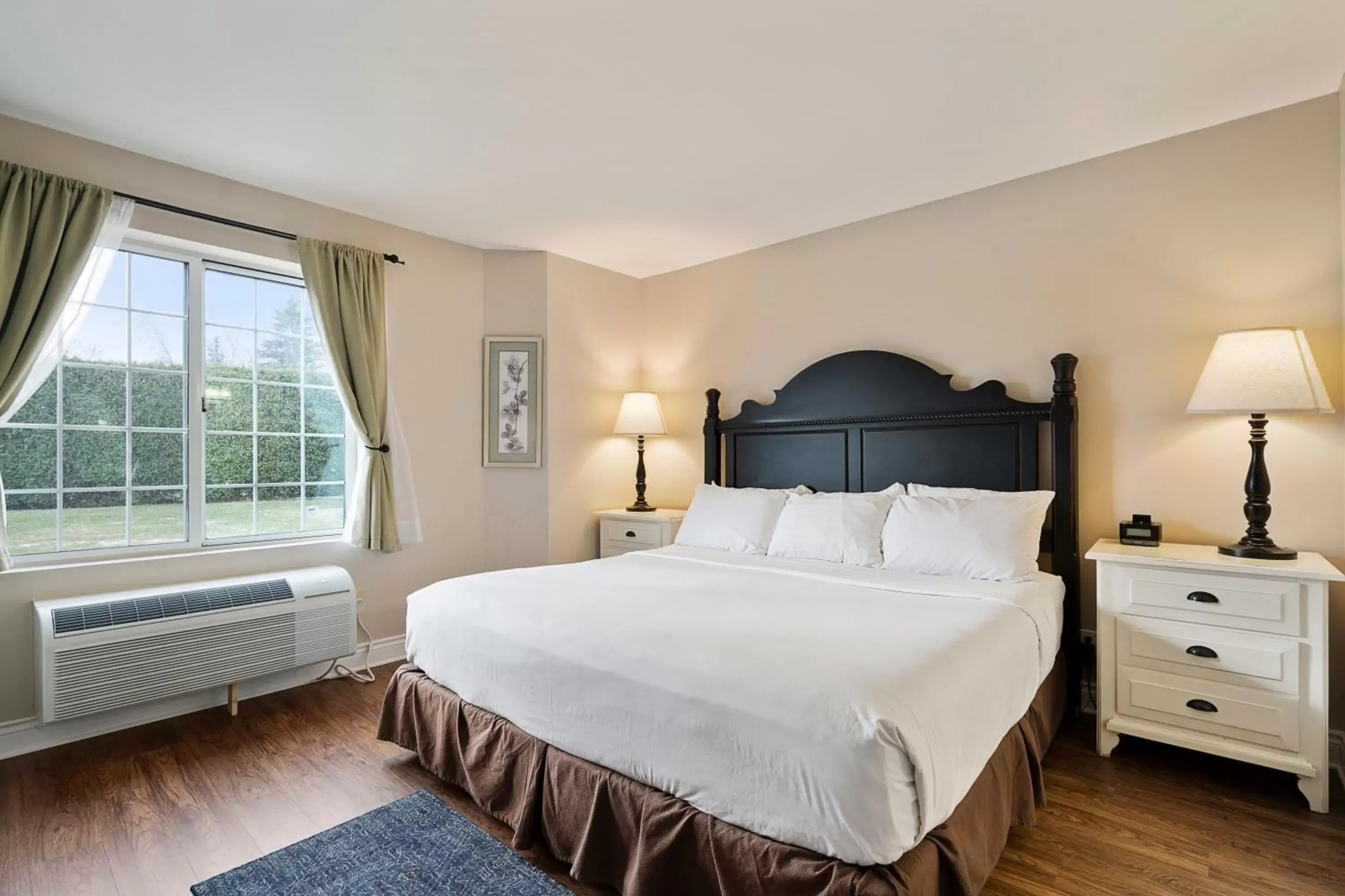 Bed in Charlevoix Inn & Suites SureStay Collection by Best Western