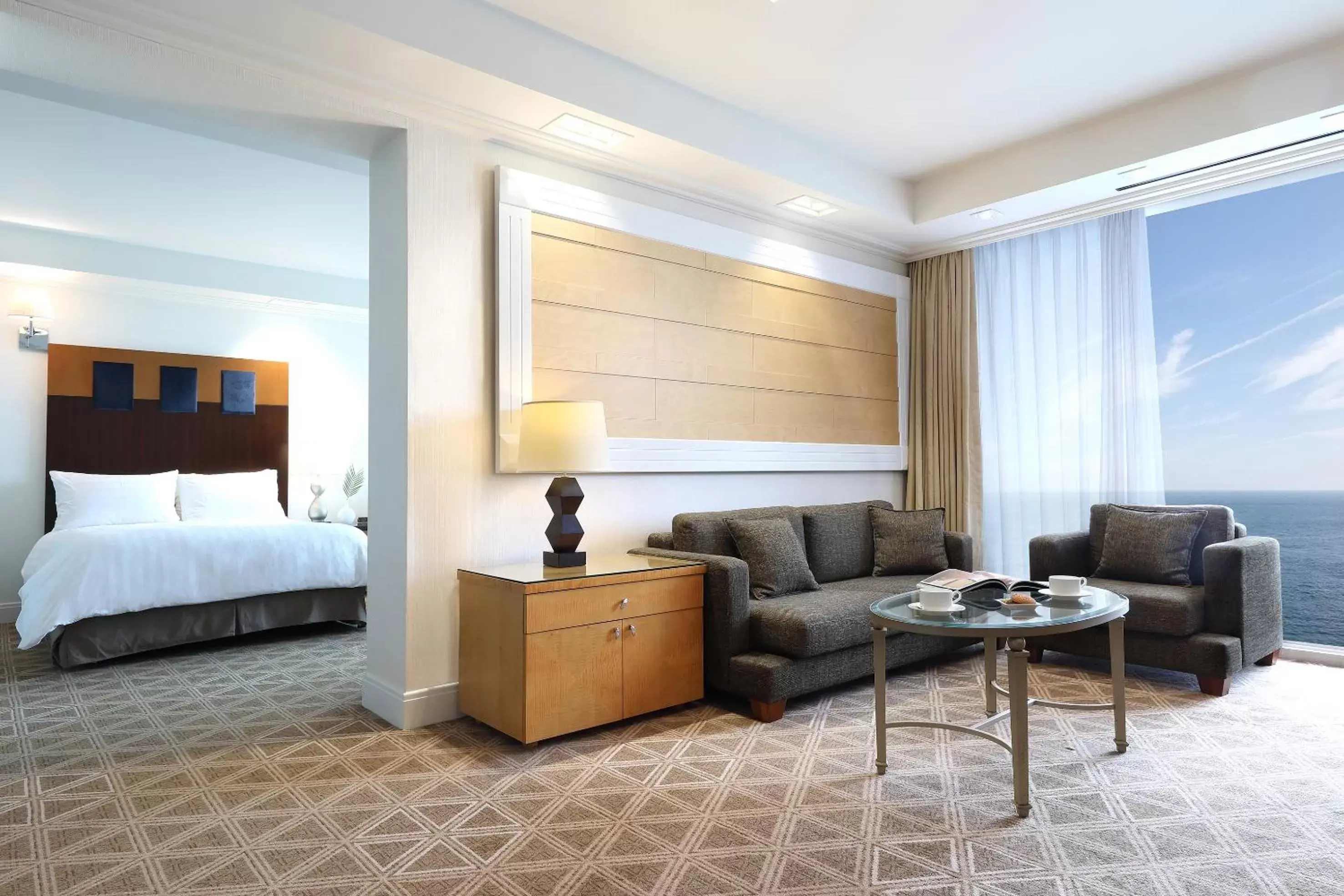 Living room in Ramada Plaza by Wyndham Jeju Ocean Front Living room in Ramada Plaza by Wyndham Jeju Ocean Front