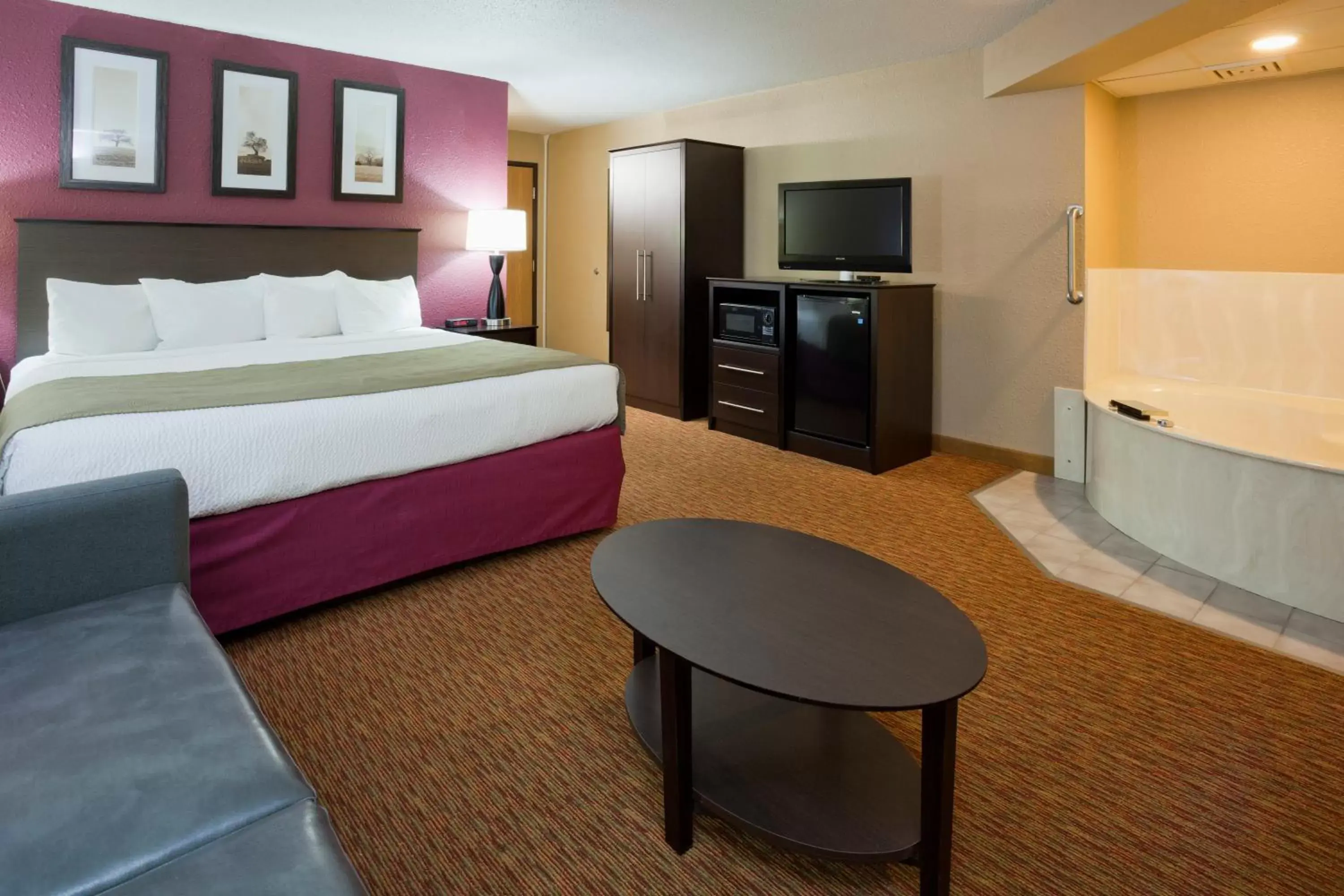 Bed in AmericInn by Wyndham Osceola