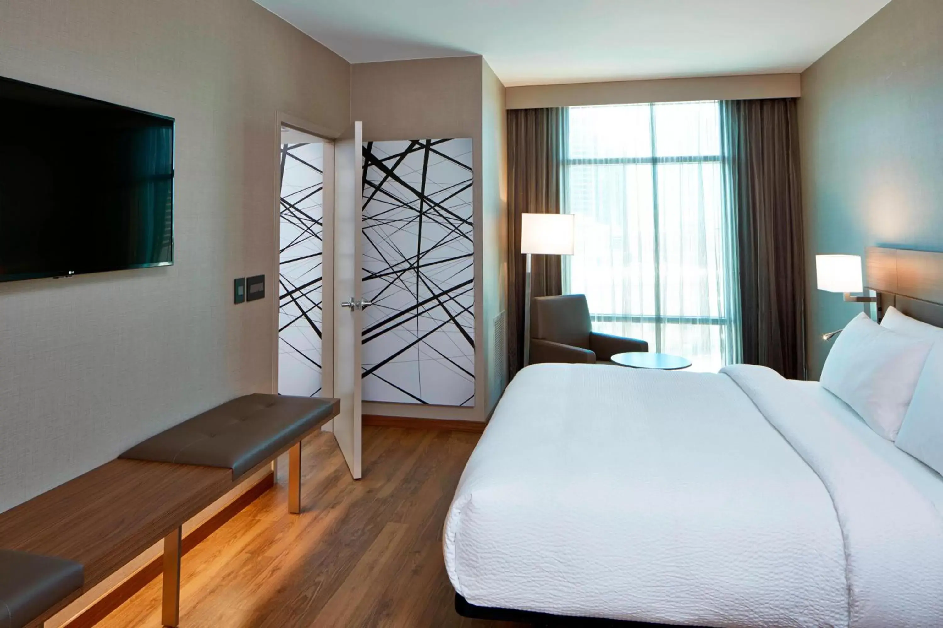 Bedroom, TV/Entertainment Center in AC Hotel by Marriott Atlanta Buckhead at Phipps Plaza