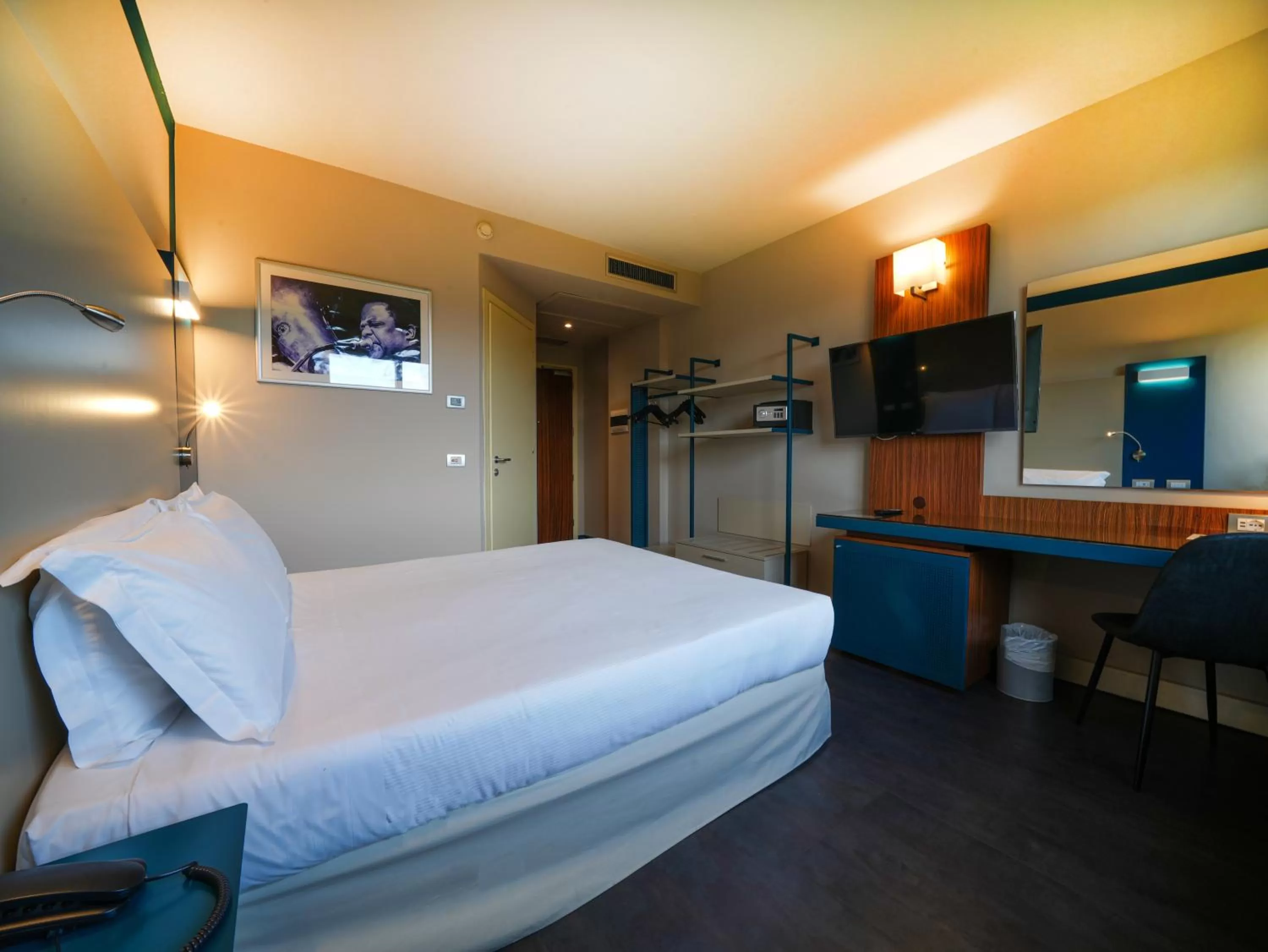 Bed in La Meridiana Bleisure Hotel