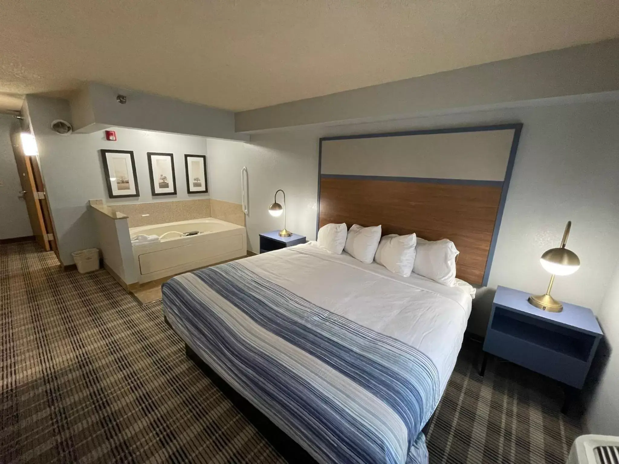 Bed in AmericInn by Wyndham Sayre