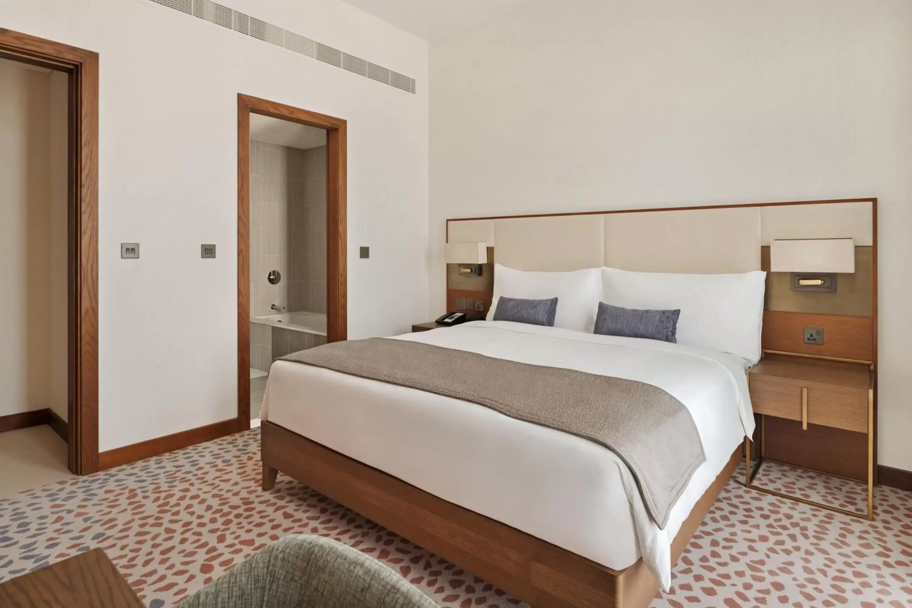 Bed in Staybridge Suites Dubai Al-Maktoum Airport, an IHG Hotel