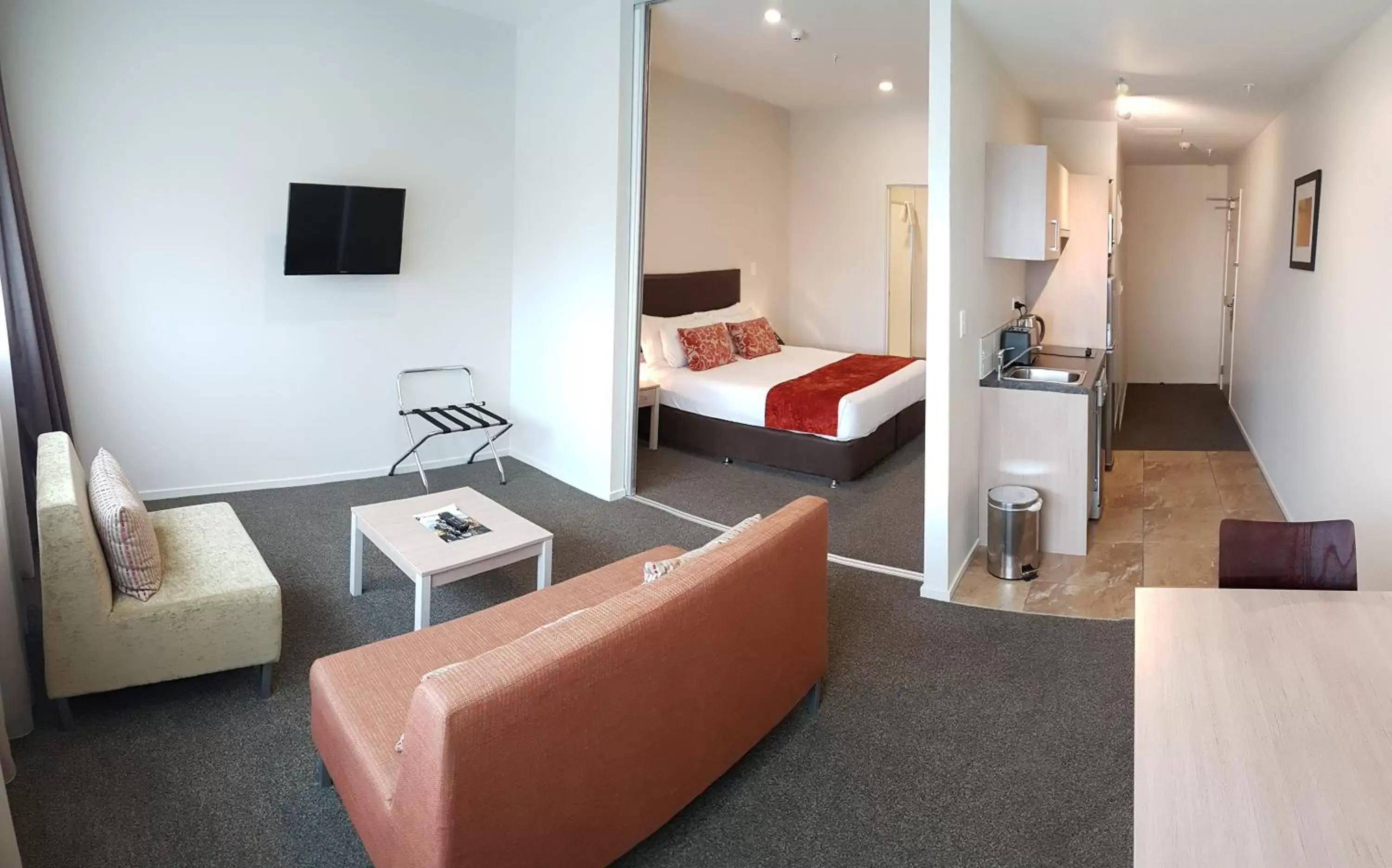 Living room, Bed in Ramada Suites by Wyndham Christchurch City