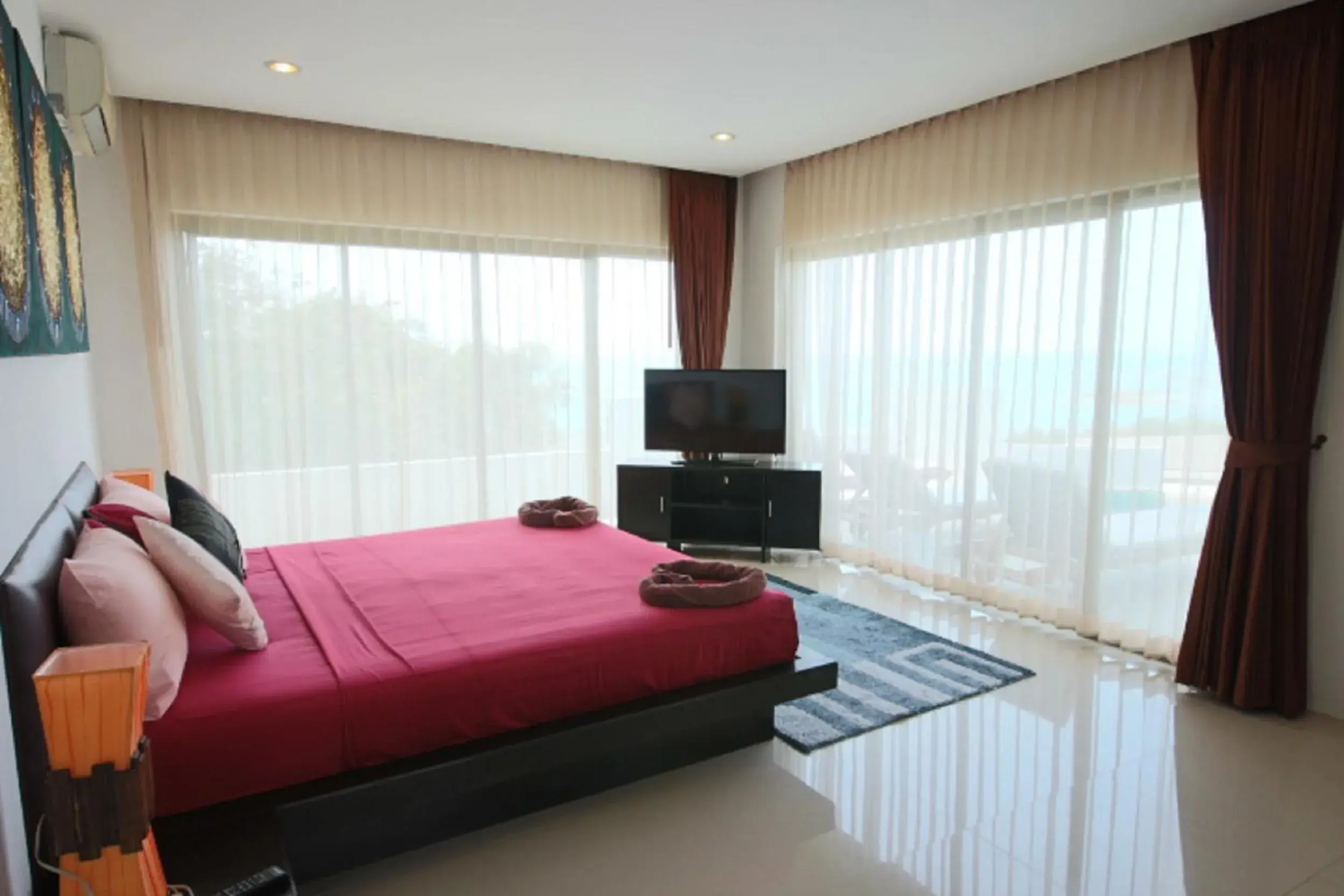 Bedroom, TV/Entertainment Center in Tropical Sea View Residence