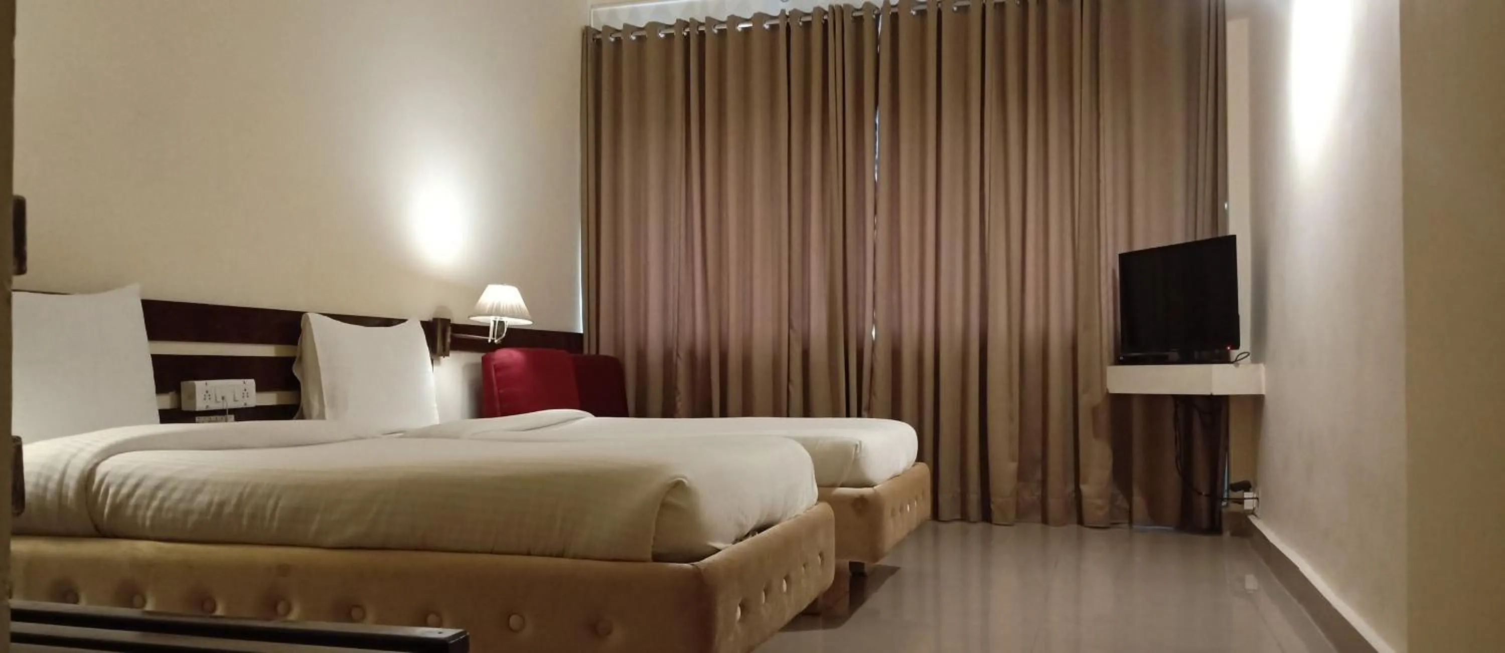 Bed in Hotel Poonja International