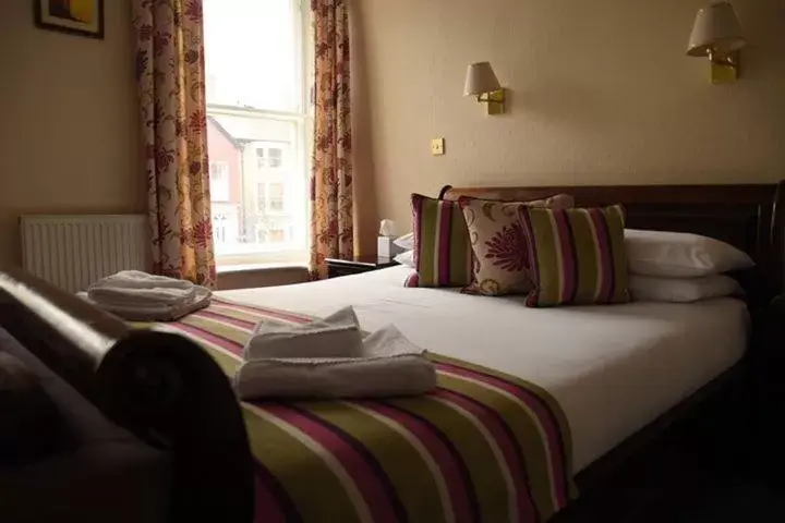 Bed in Harry's Hotel & Restaurant