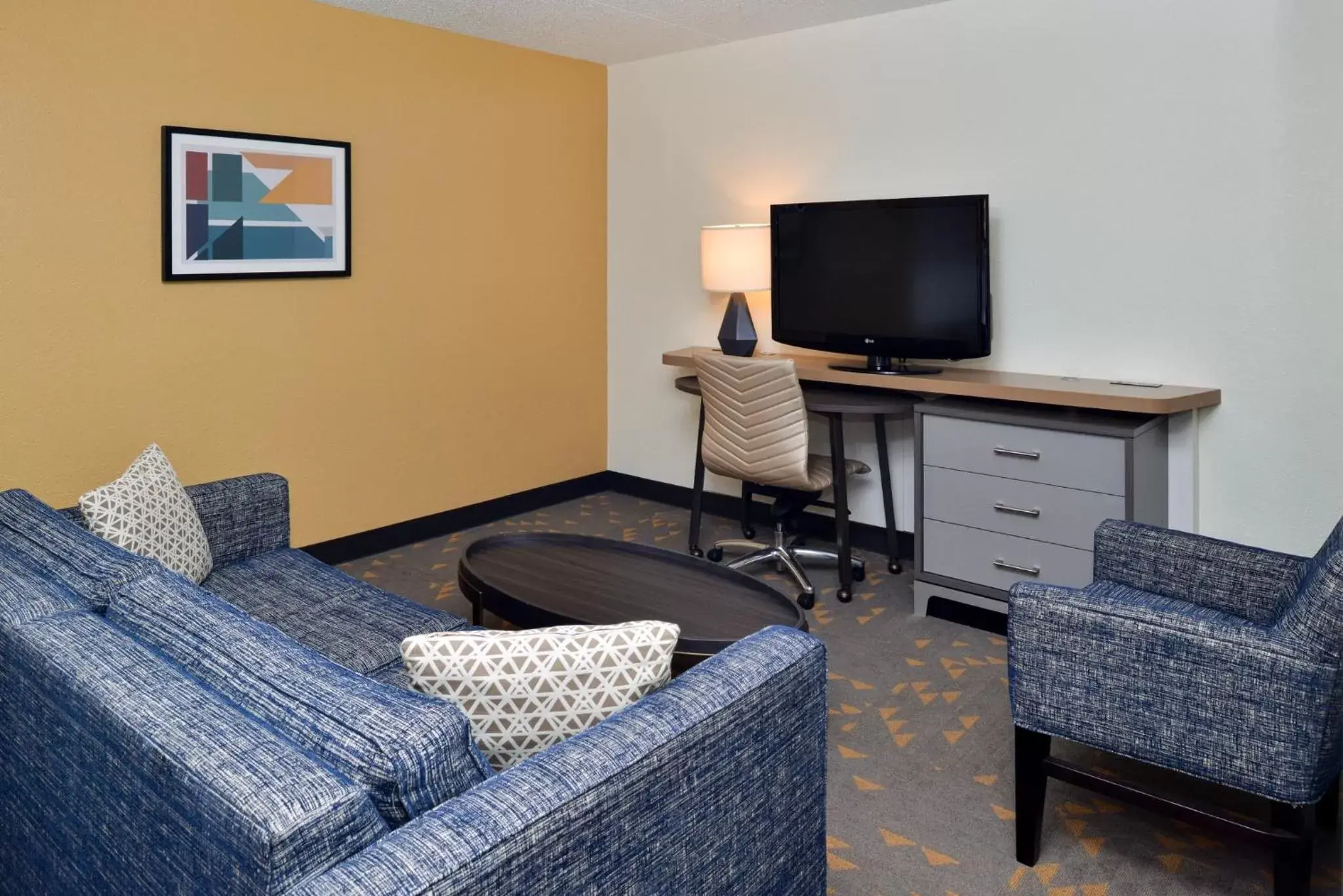 Photo of the whole room, TV/Entertainment Center in Holiday Inn Hotel & Suites Overland Park-Convention Center, an IHG Hotel