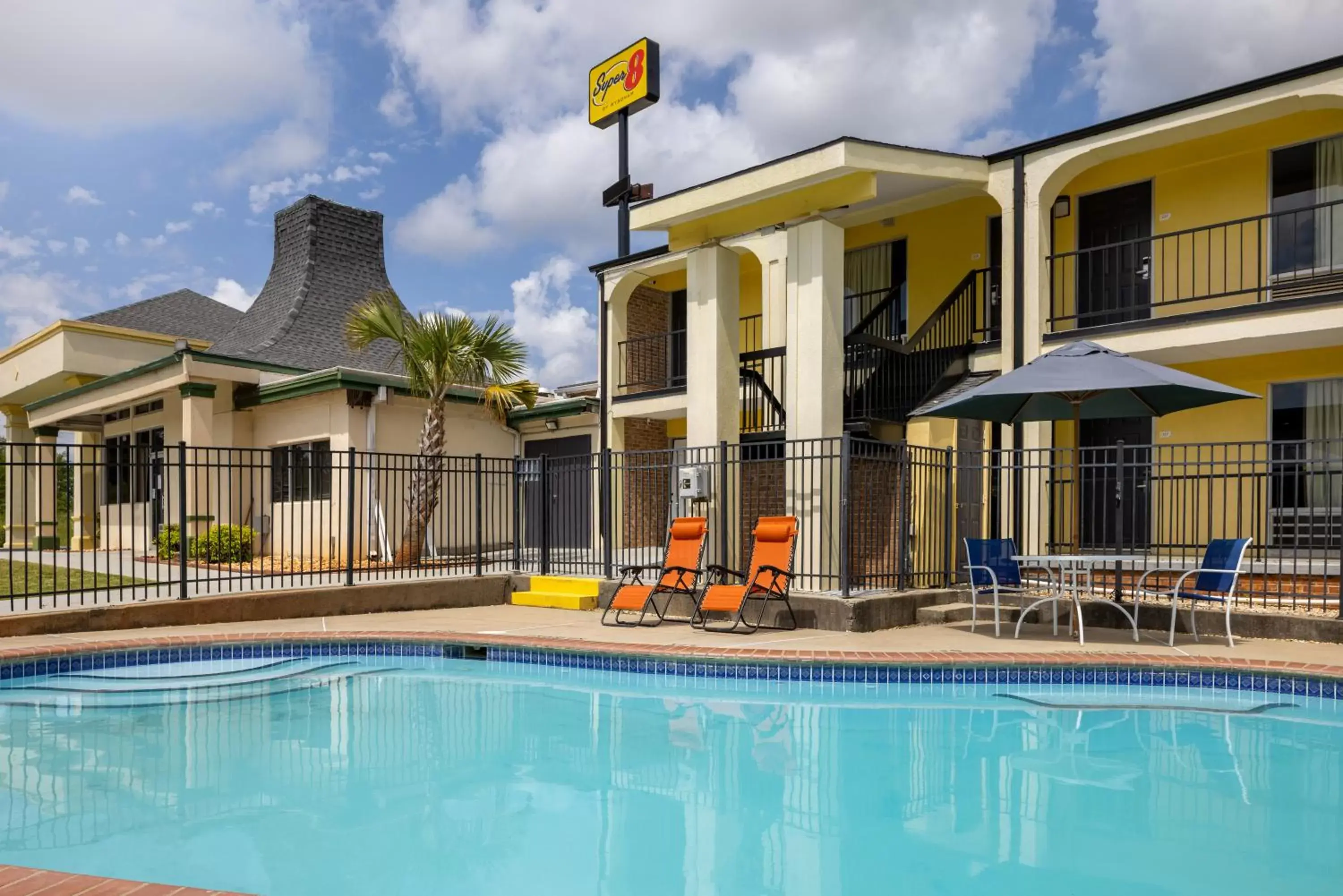 Swimming pool, Property Building in Super 8 by Wyndham McDonough GA