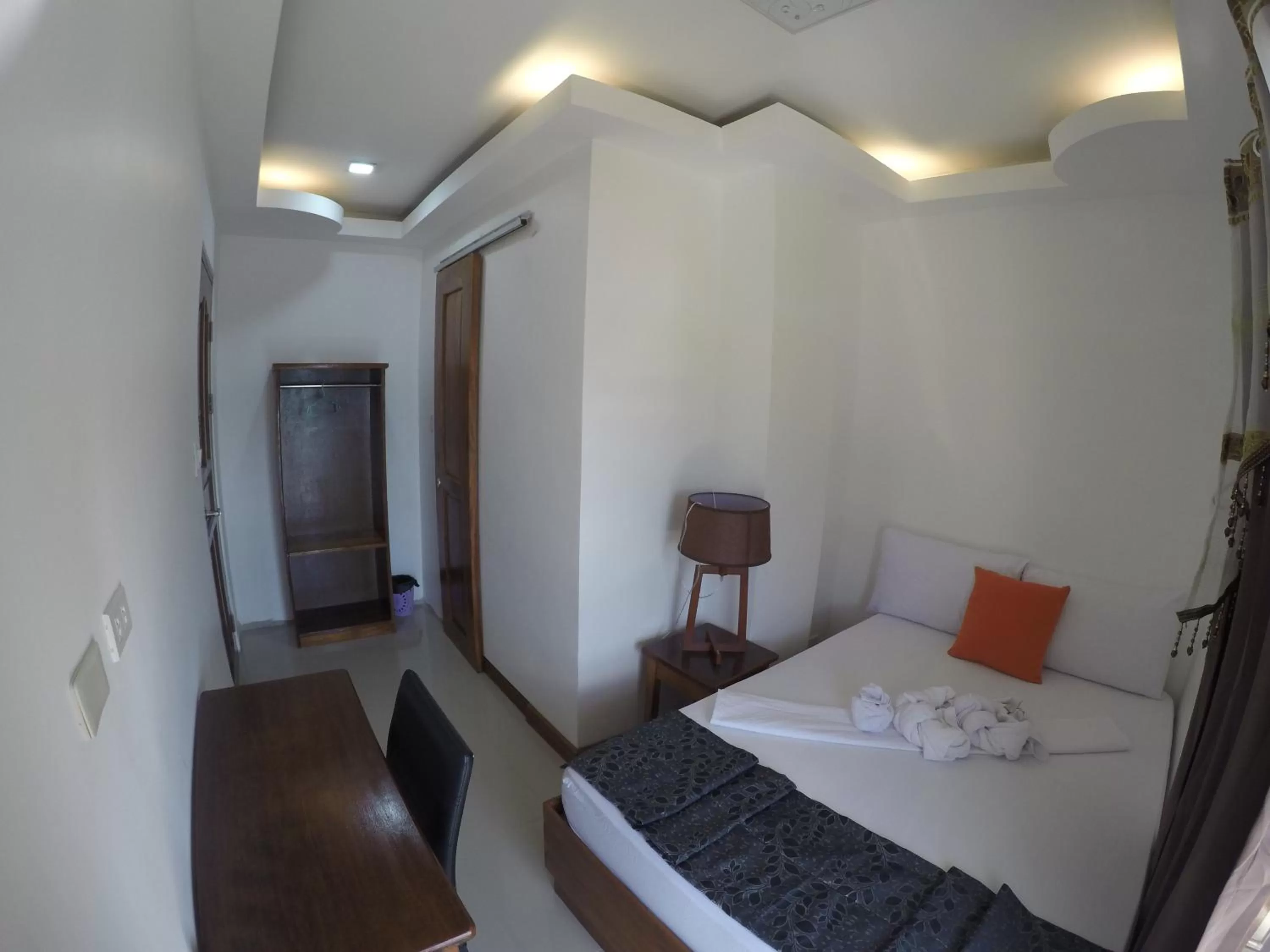 Bed in El Nido Royal Palm Inn