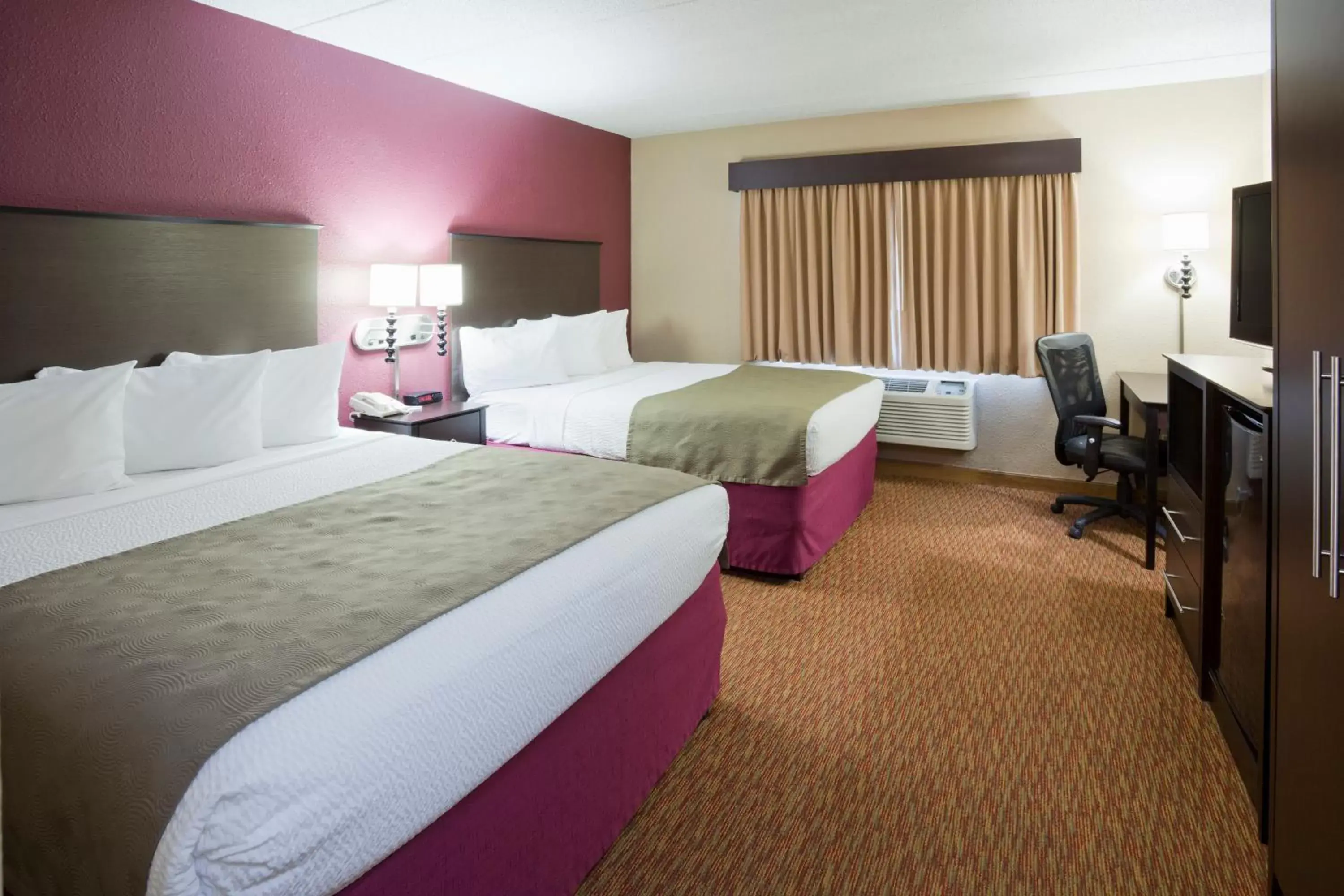 Bed in AmericInn by Wyndham Osceola