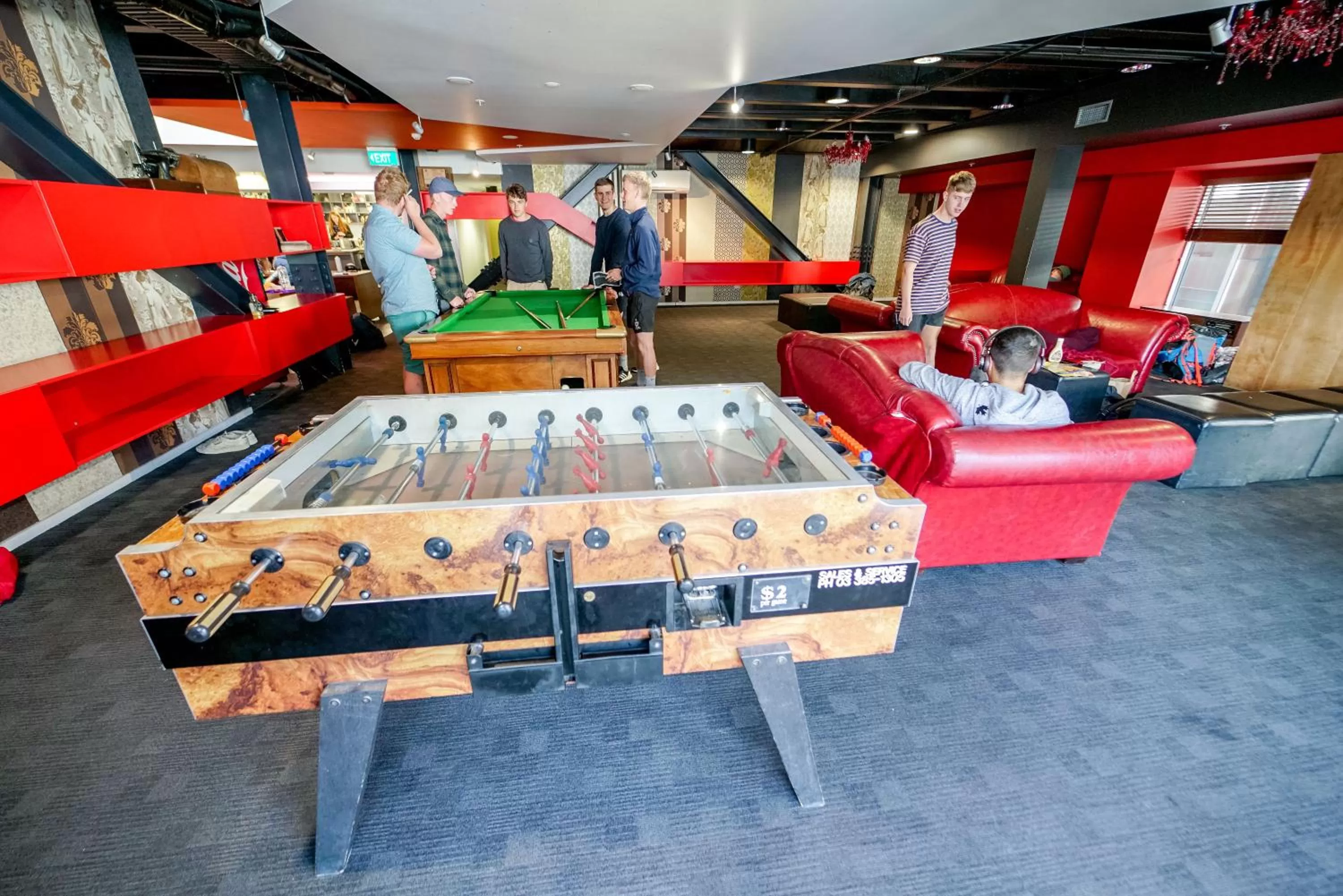 Communal lounge/ TV room in Nomads Queenstown Hostel