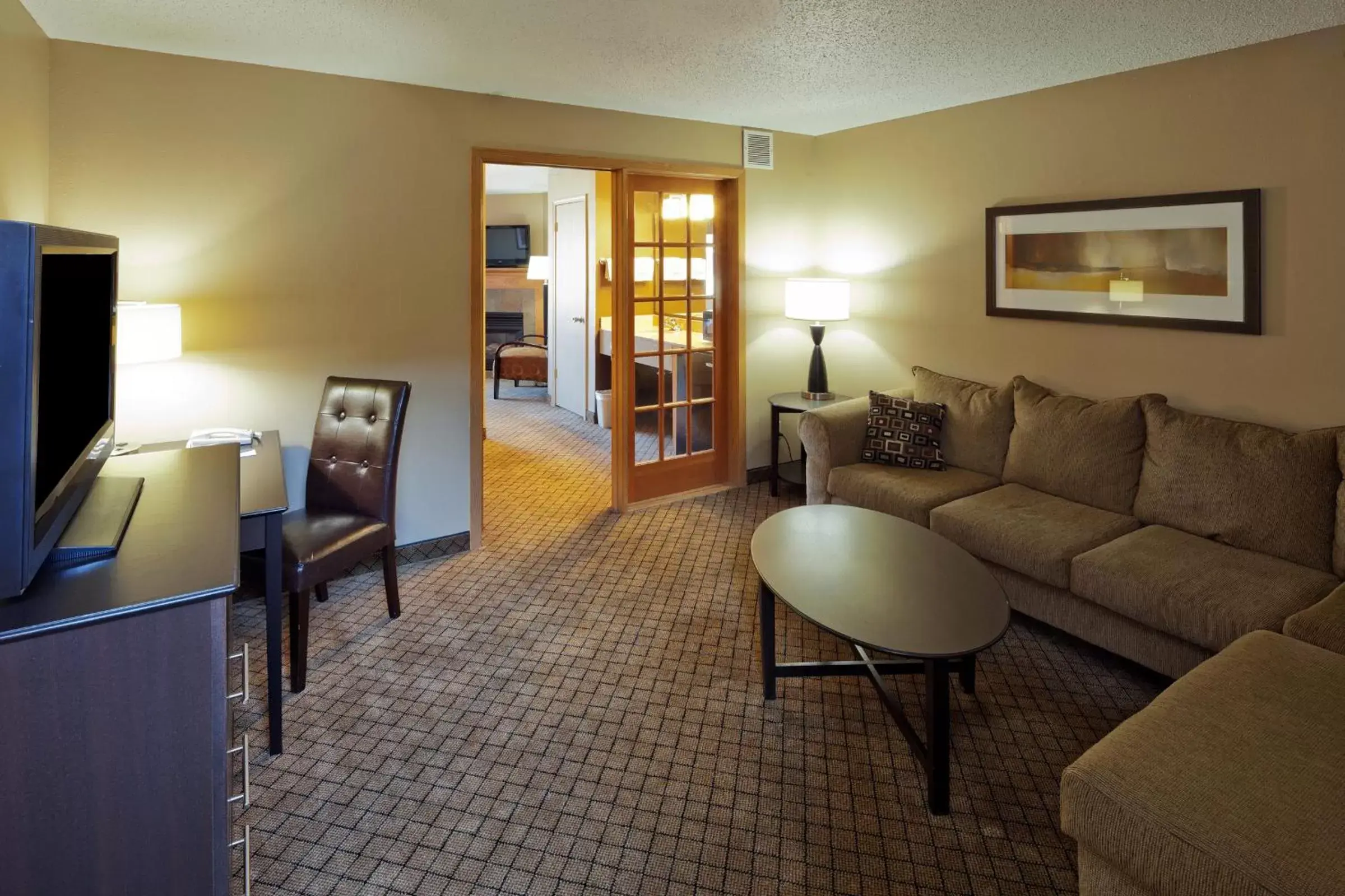 Living room, Seating Area in AmericInn by Wyndham Hartford WI