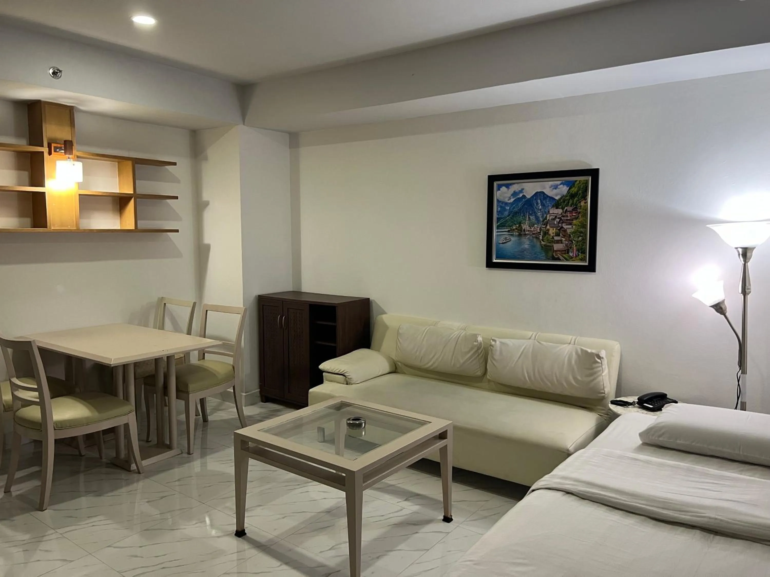 Living room, Bed in Mall Suites Hotel