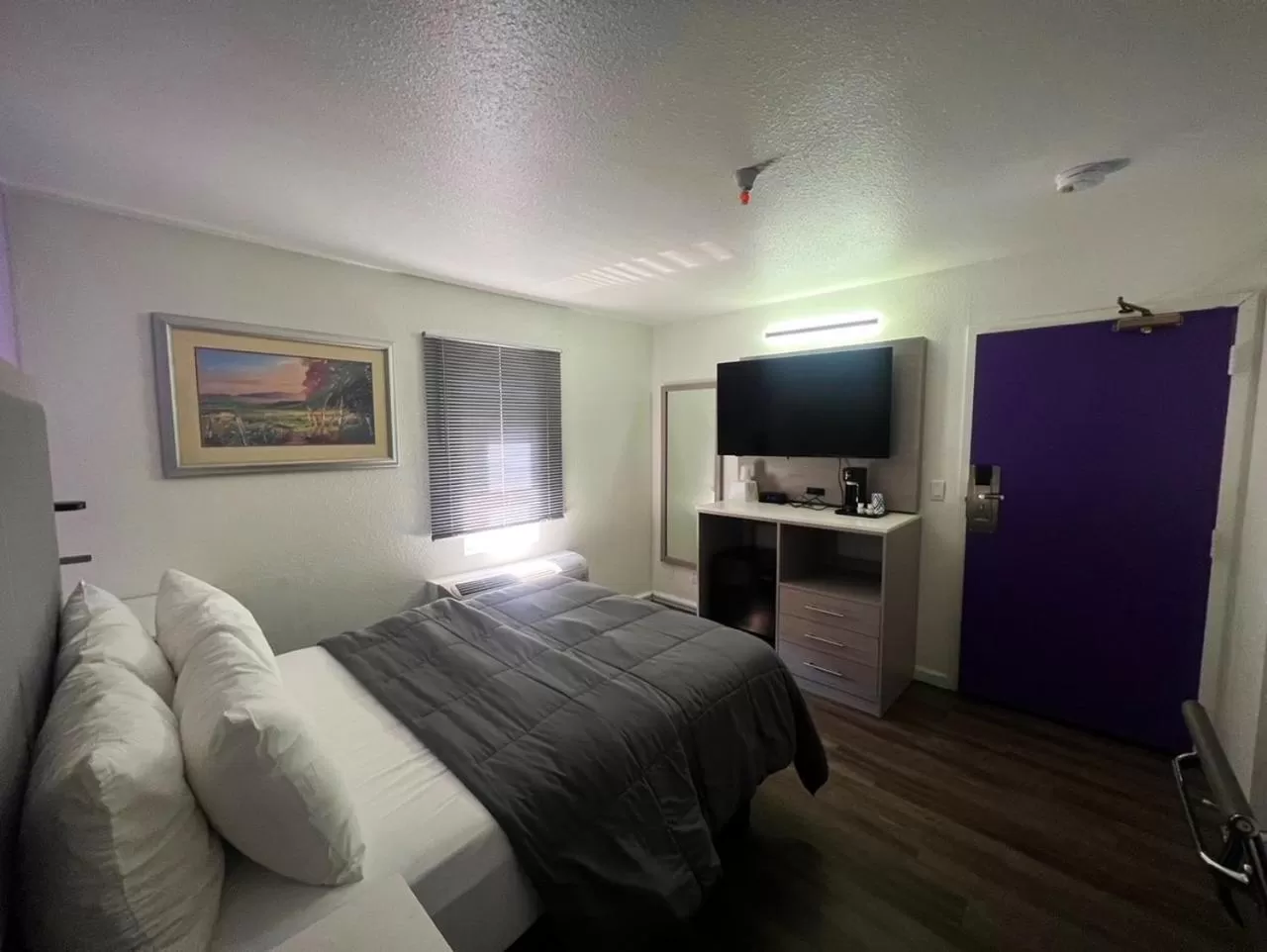 Bed in The Aqua Pacific Hotel