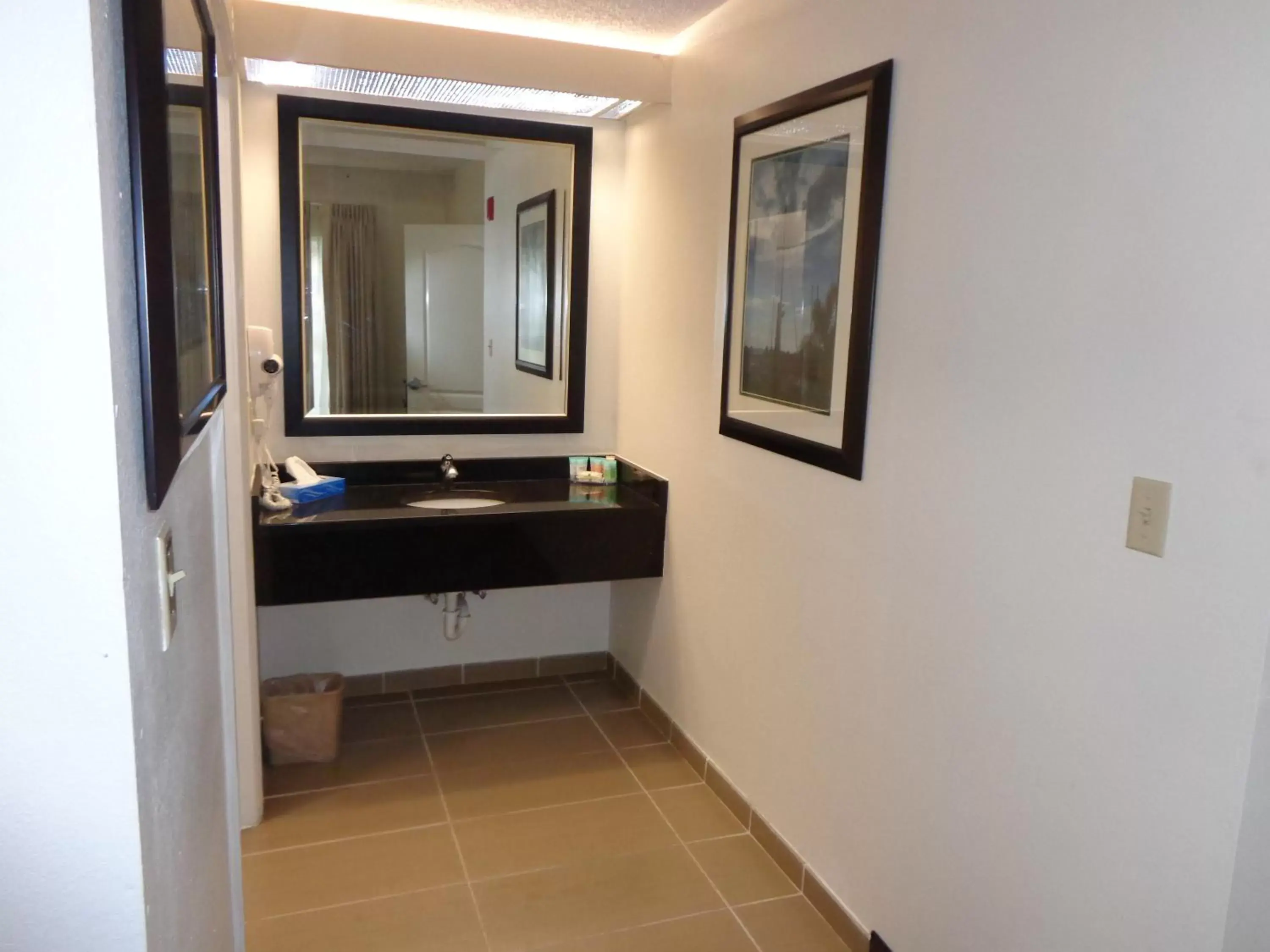 Bathroom in SureStay Plus by Best Western Orlando Lake Buena Vista