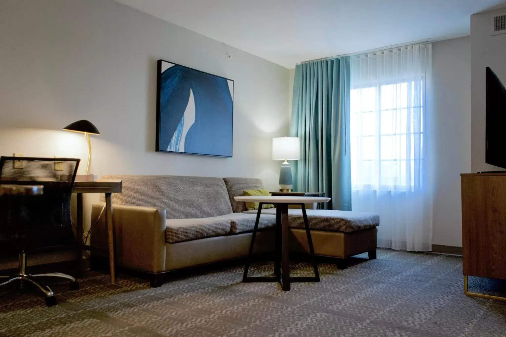 Bedroom, Seating Area in Staybridge Suites Akron-Stow-Cuyahoga Falls, an IHG Hotel