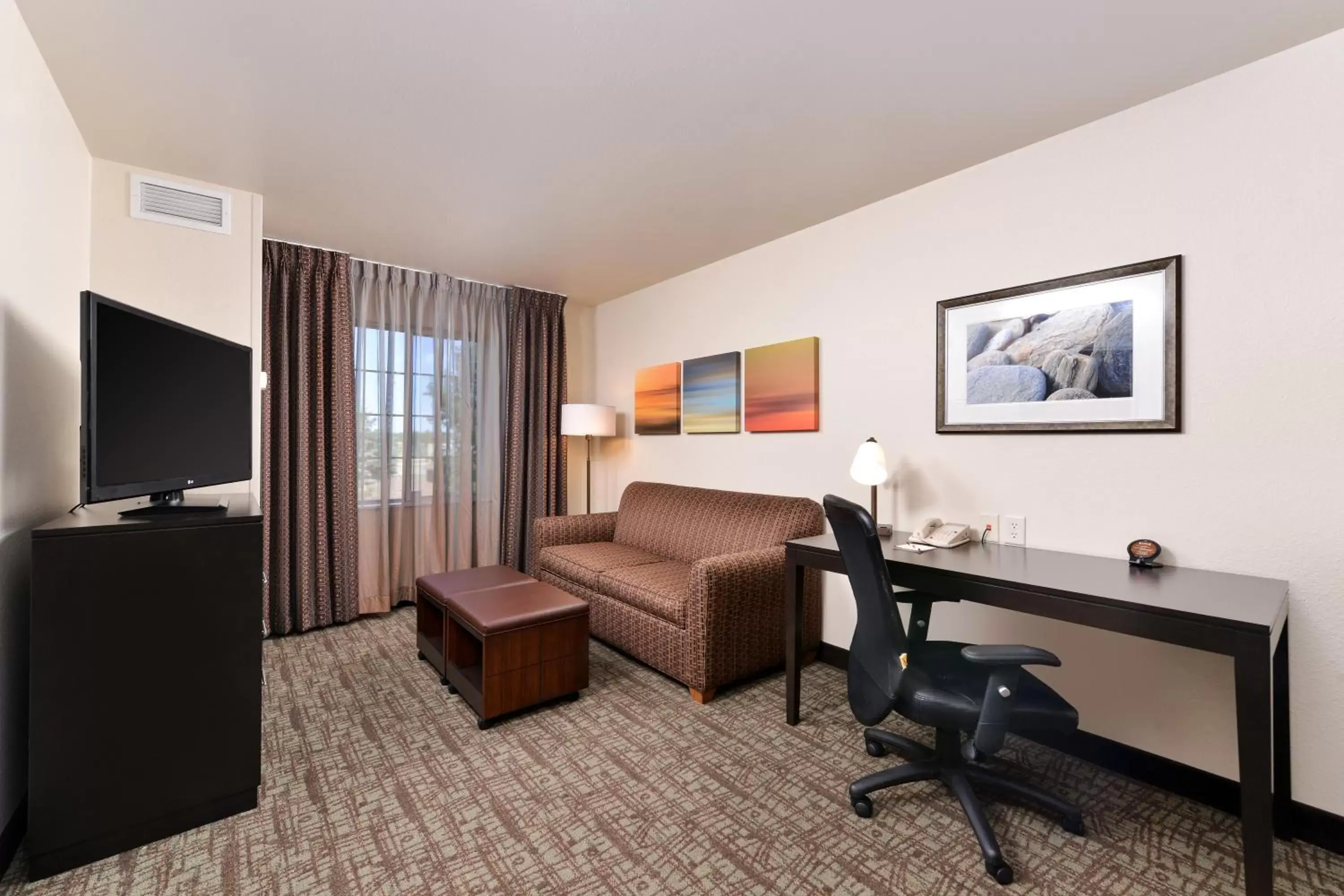 Photo of the whole room, TV/Entertainment Center in Staybridge Suites Sioux Falls at Empire Mall, an IHG Hotel