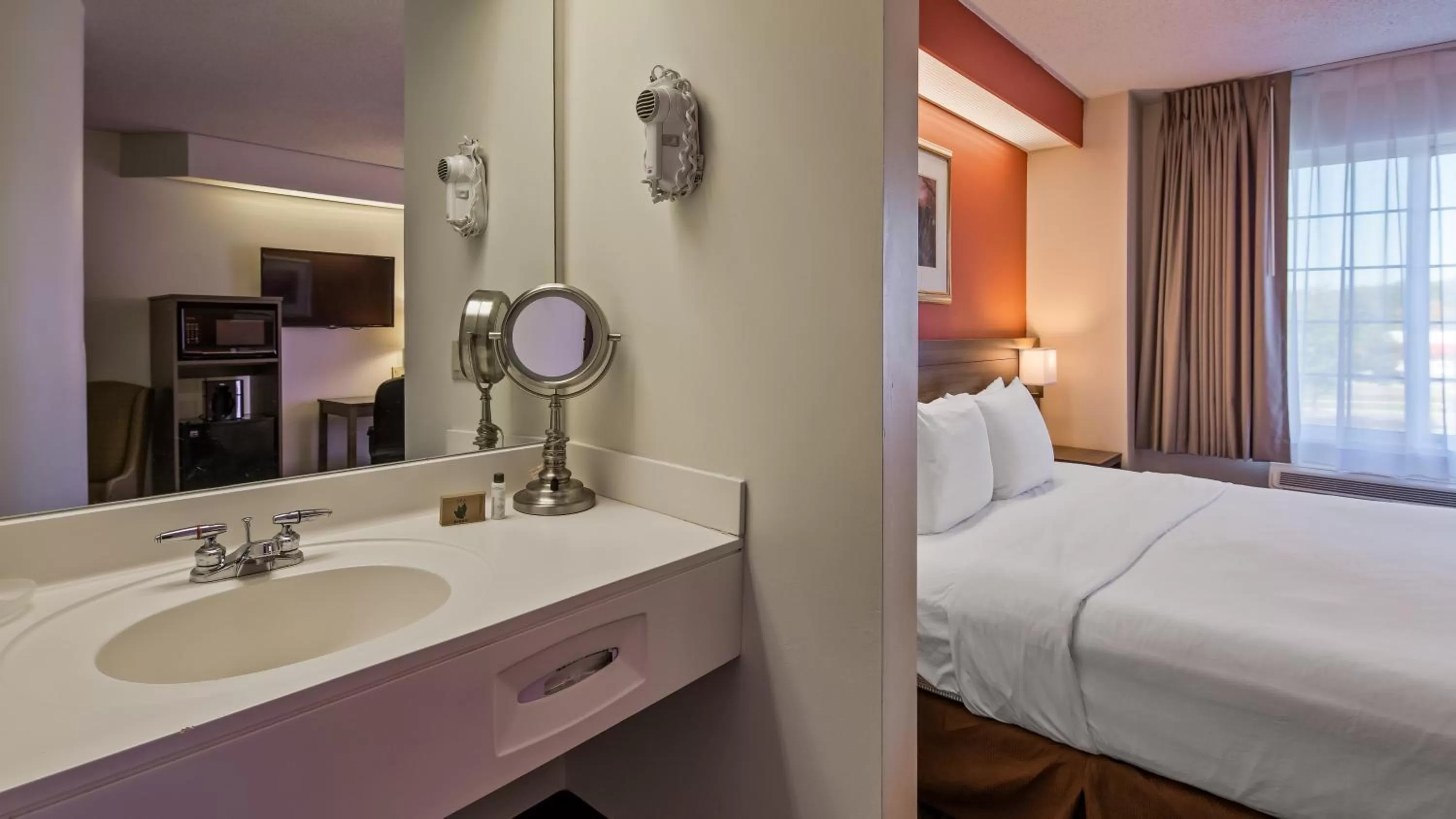 Bathroom, Bed in Charlevoix Inn & Suites SureStay Collection by Best Western