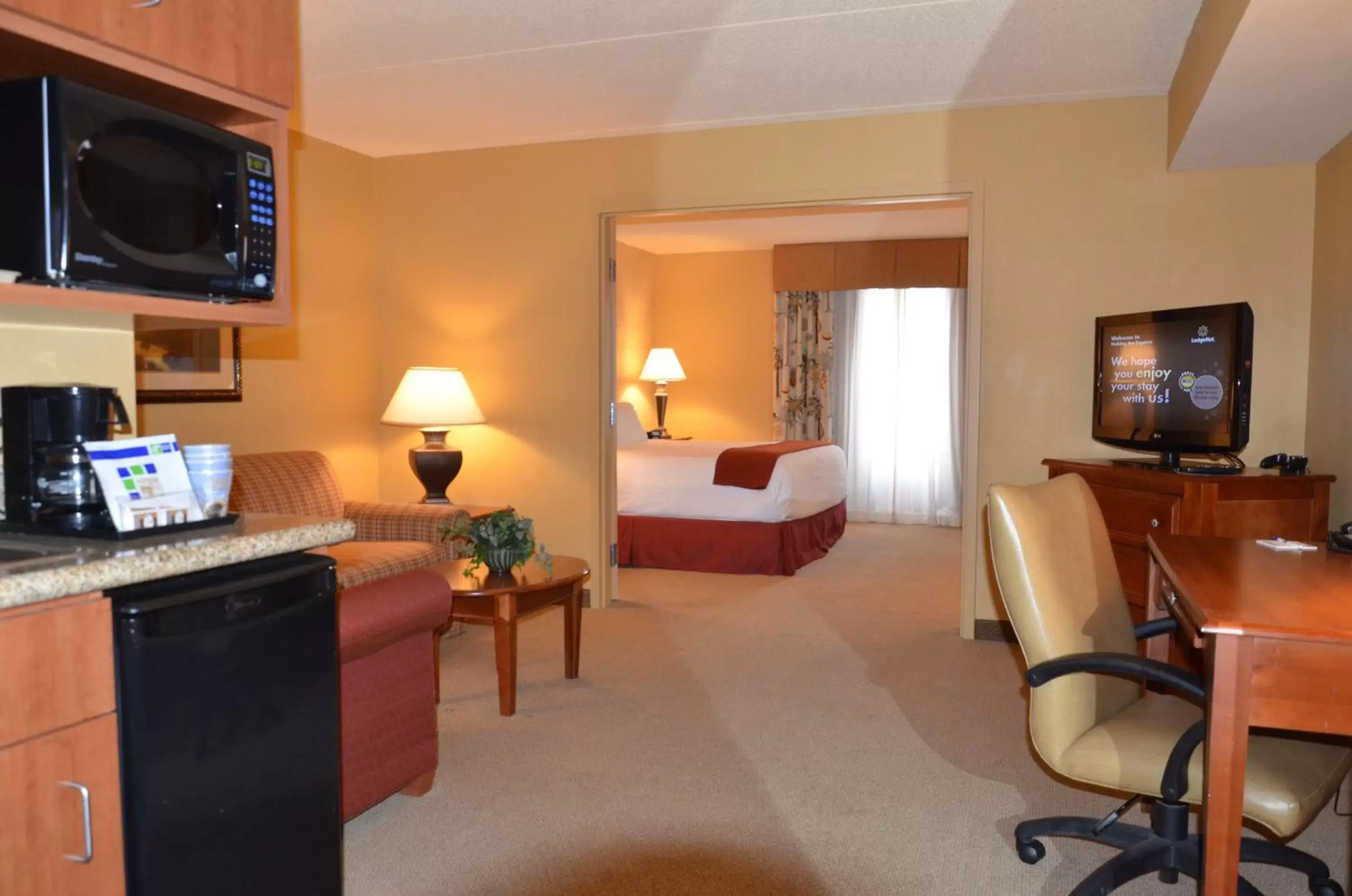 Photo of the whole room, TV/Entertainment Center in Holiday Inn Express & Suites Bloomington, an IHG Hotel