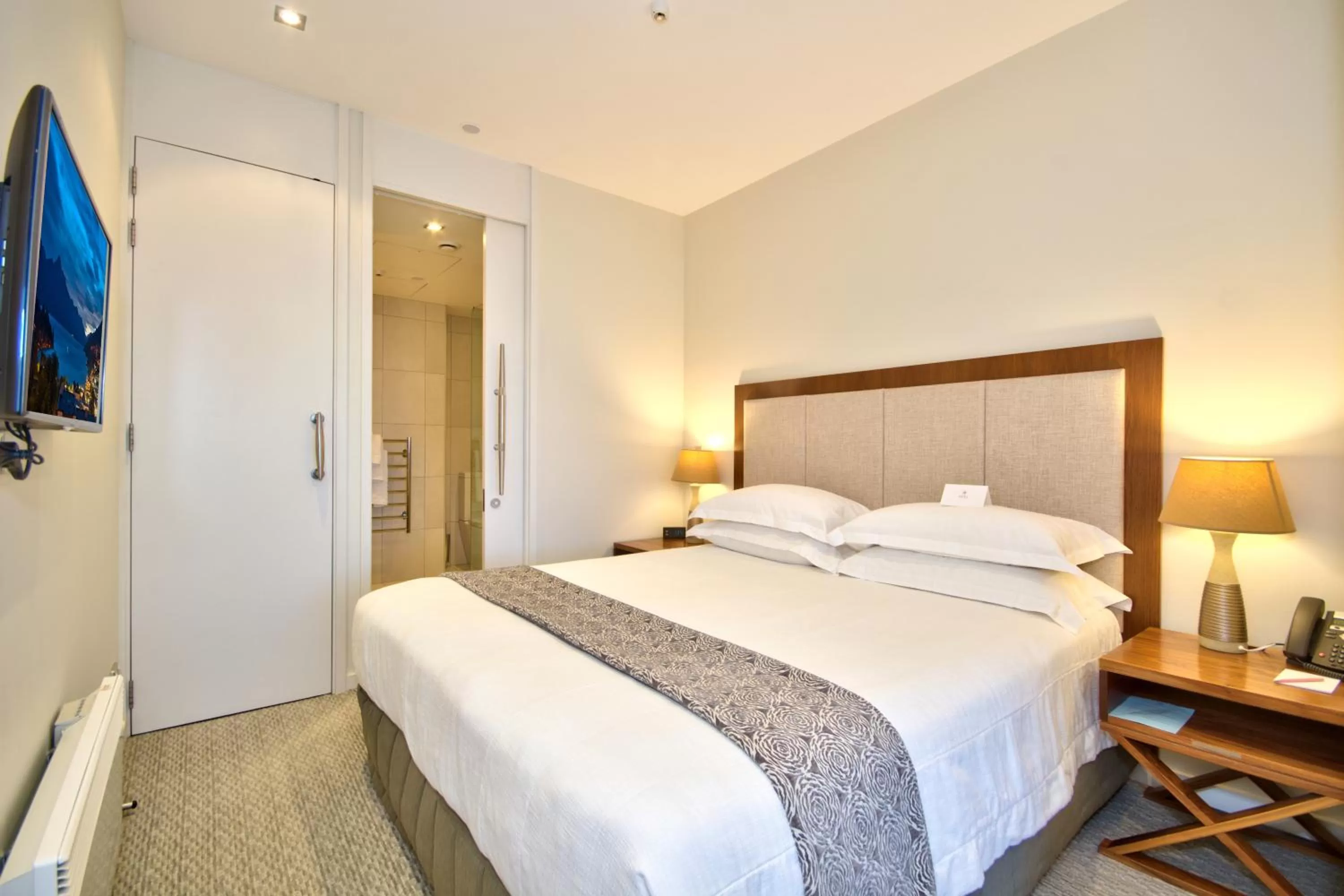 Bed in The Rees Hotel & Luxury Apartments