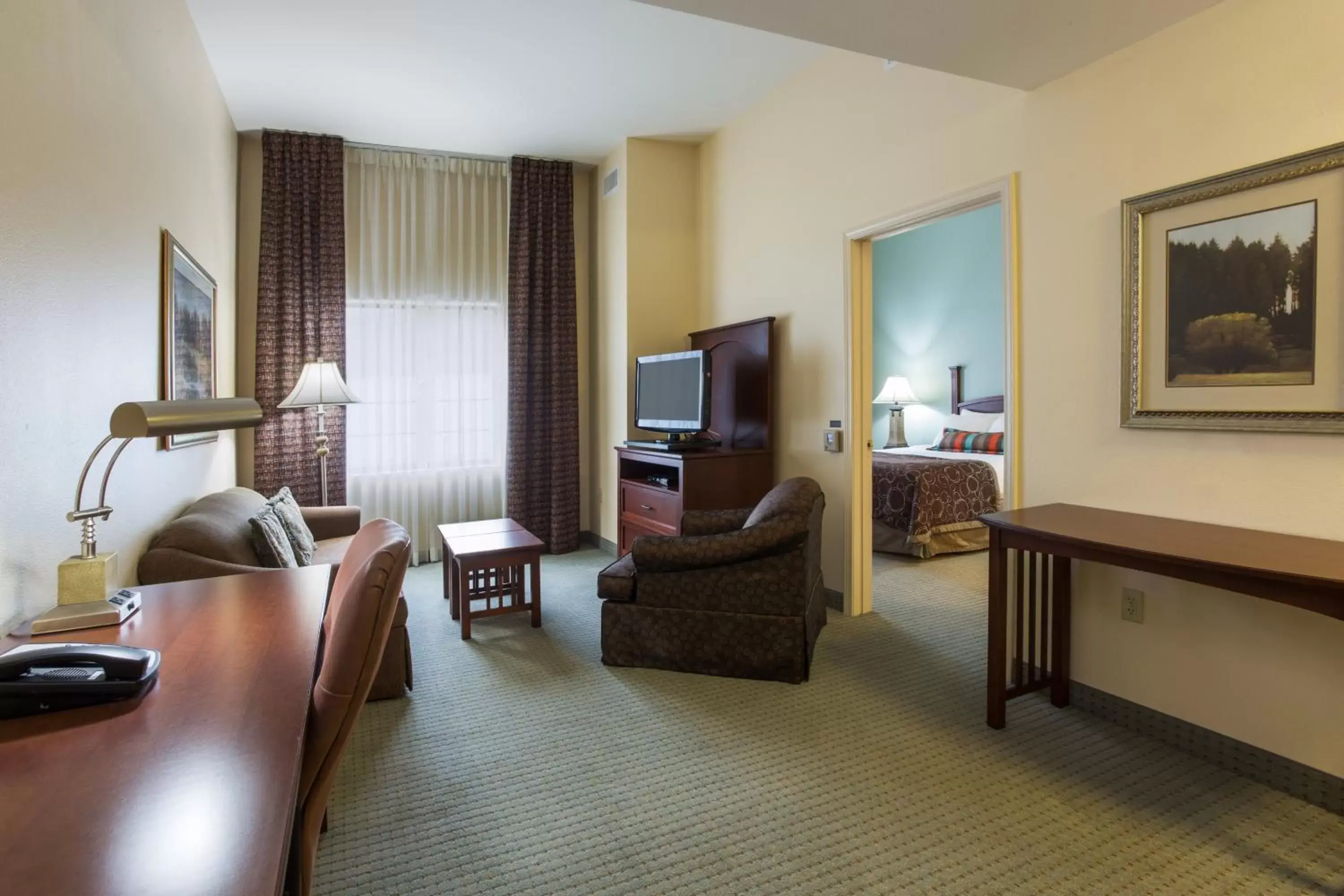 Photo of the whole room, Seating Area in Staybridge Suites Tallahassee I-10 East, an IHG Hotel