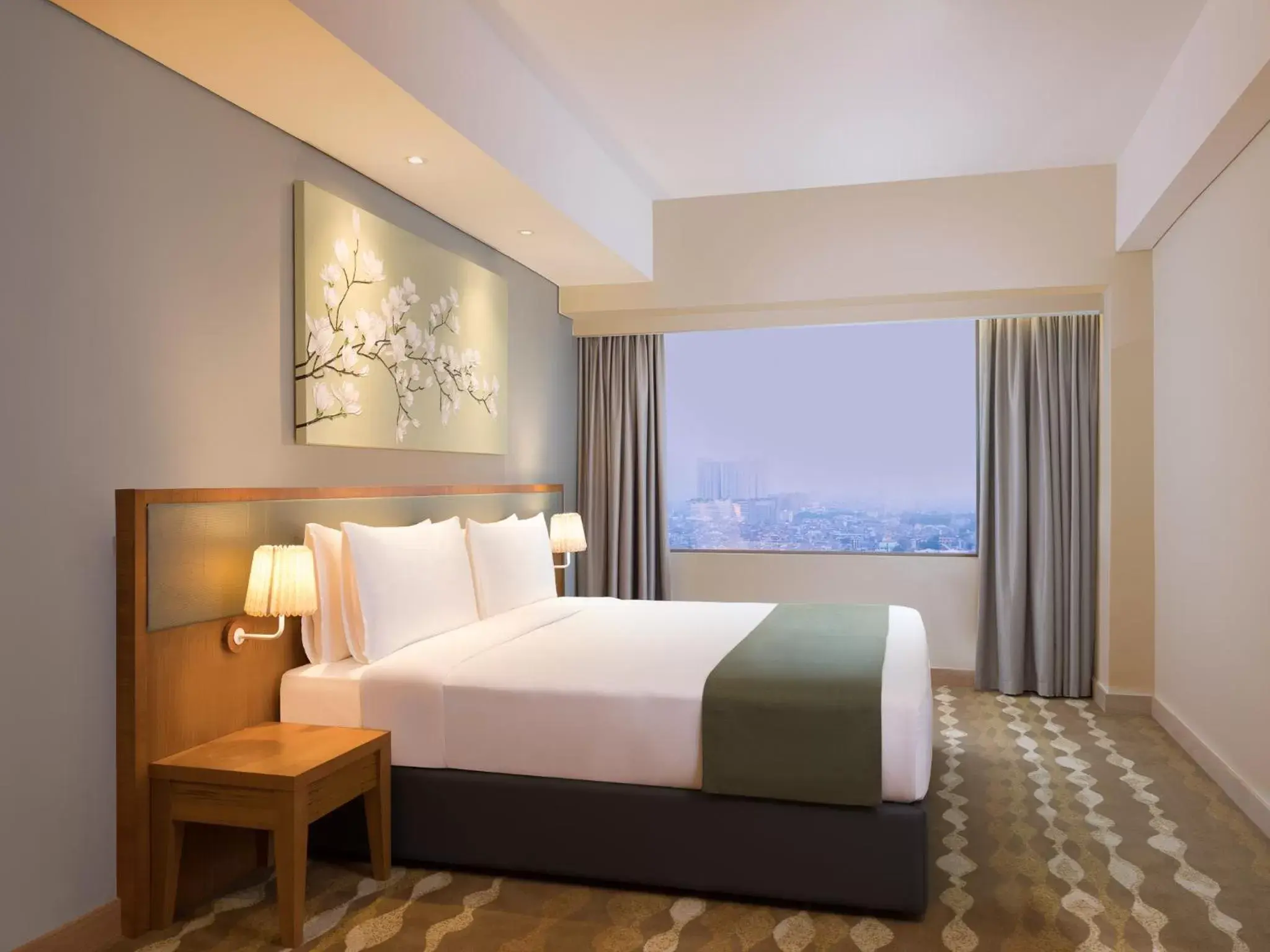 Bed in Holiday Inn & Suites Jakarta Gajah Mada, an IHG Hotel