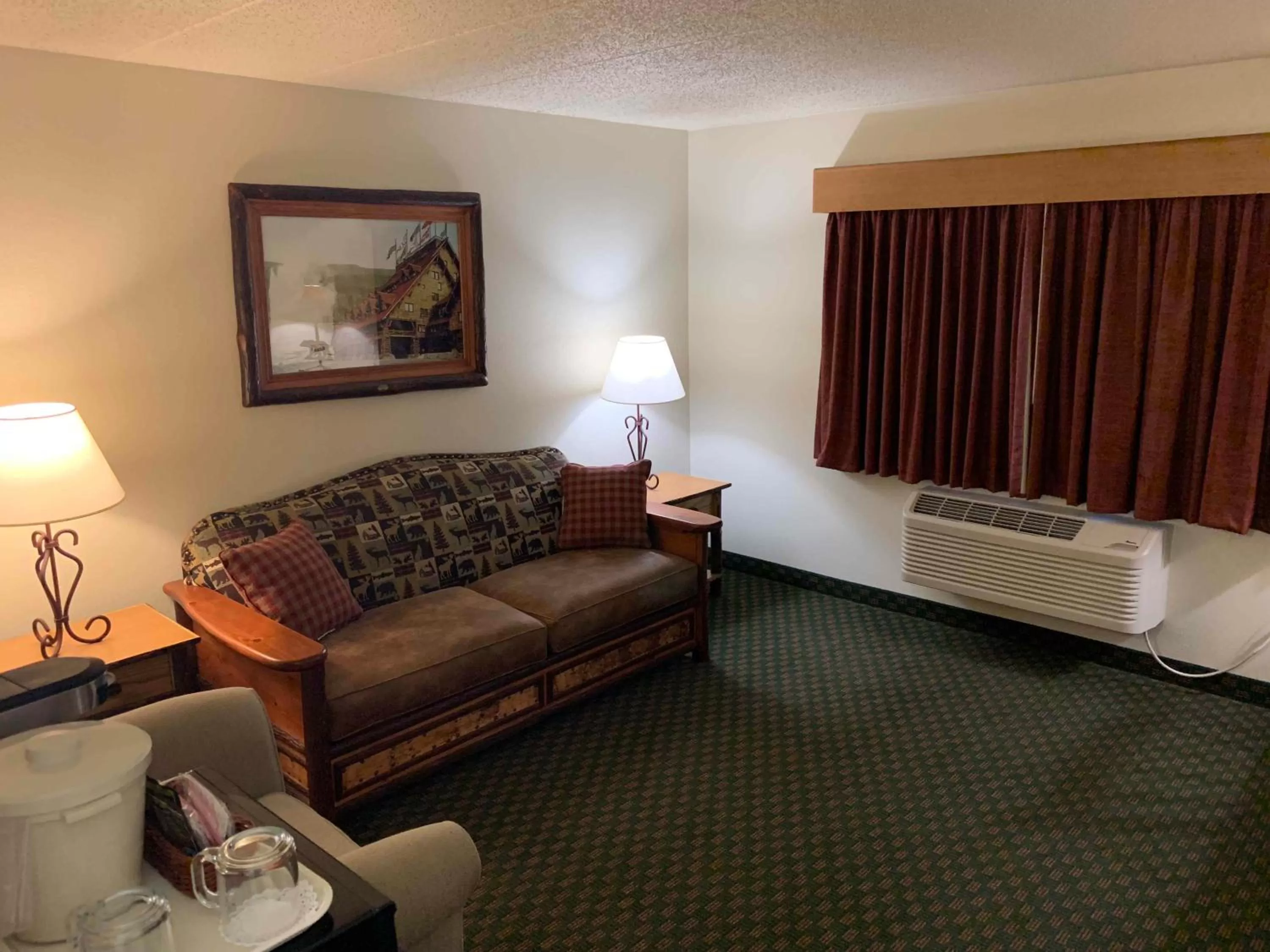 Living room, Bed in AmericInn by Wyndham Cody