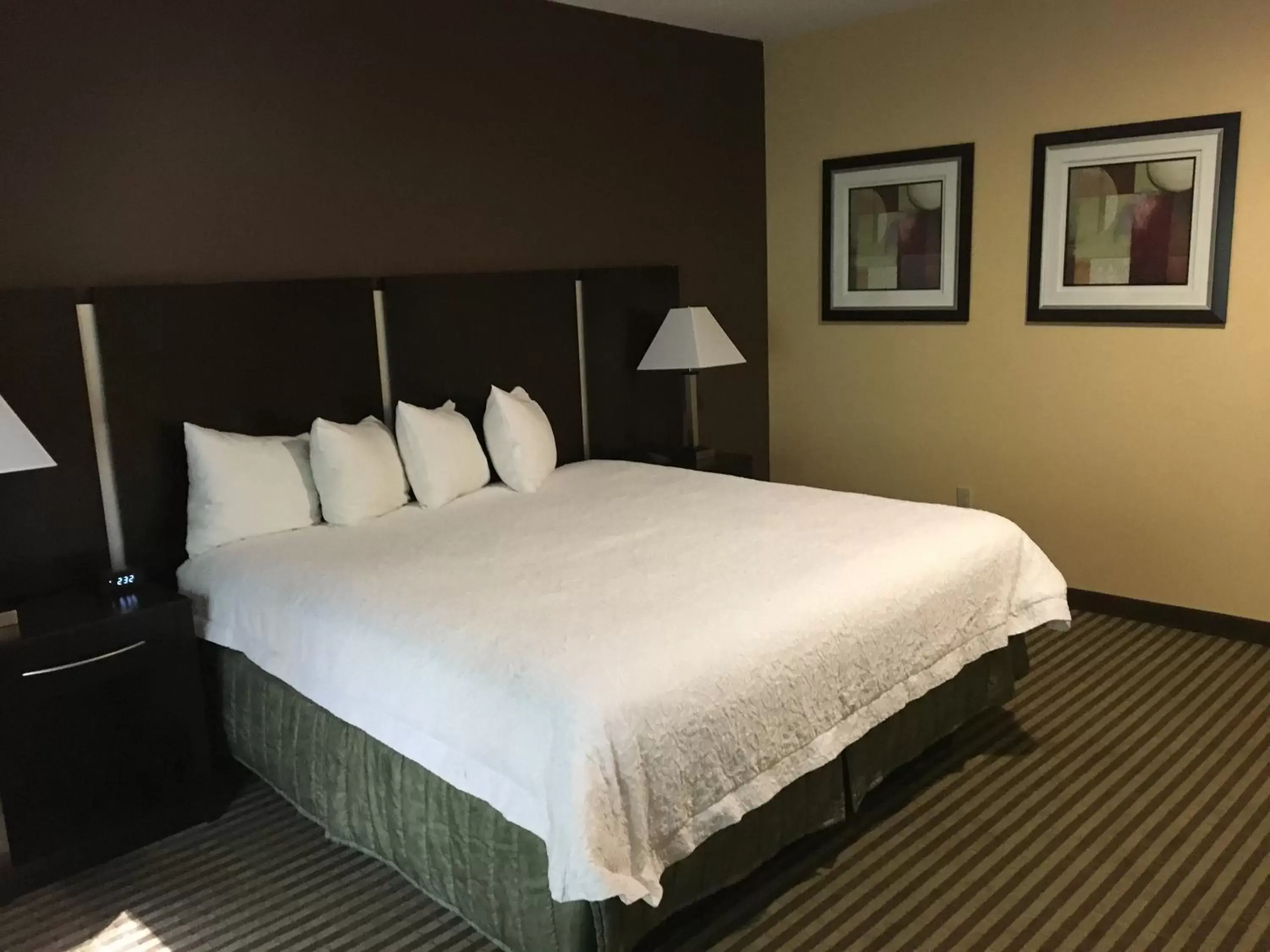 Bed in Whitney Inn & Suites